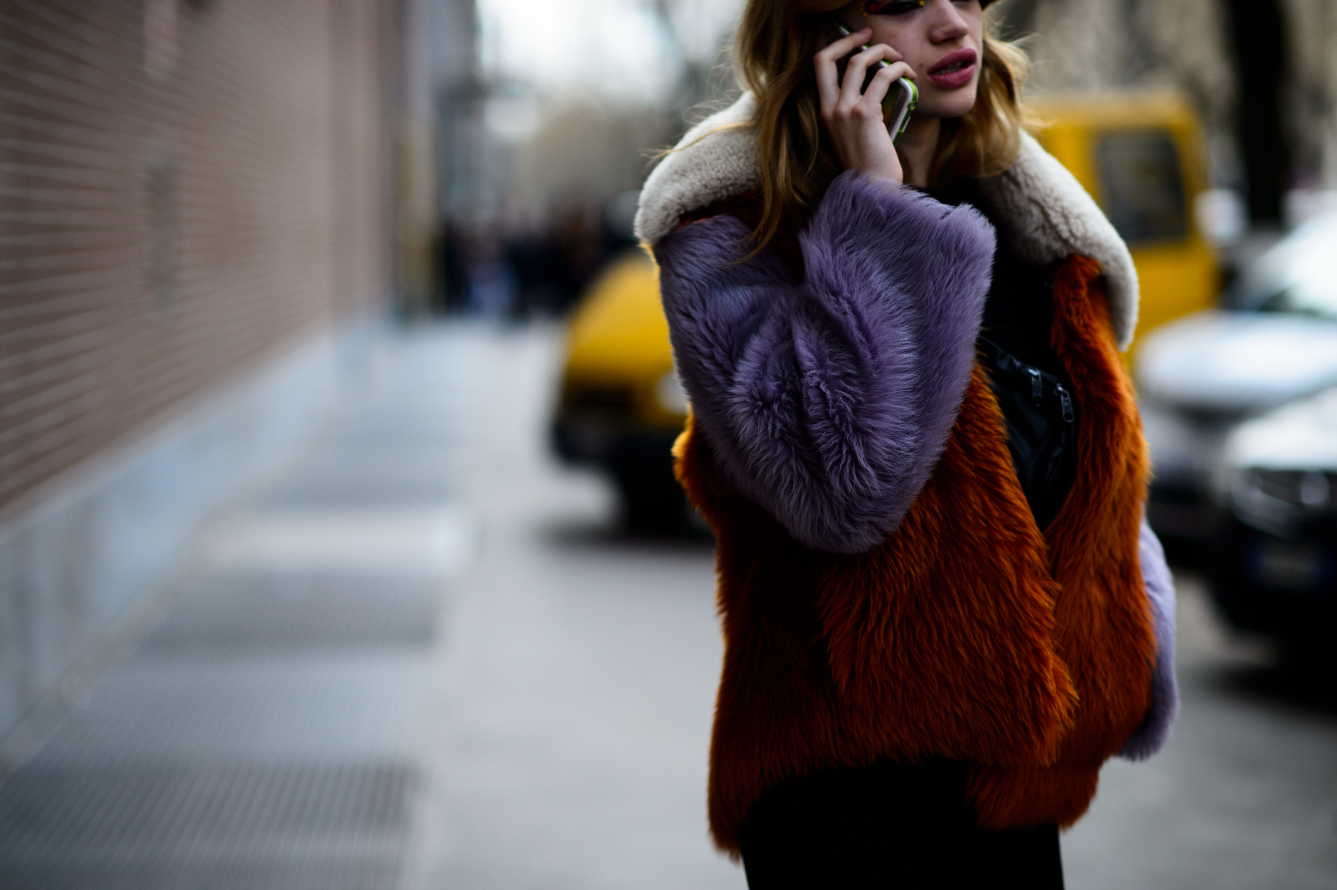 Model wearing faux fur coat after show