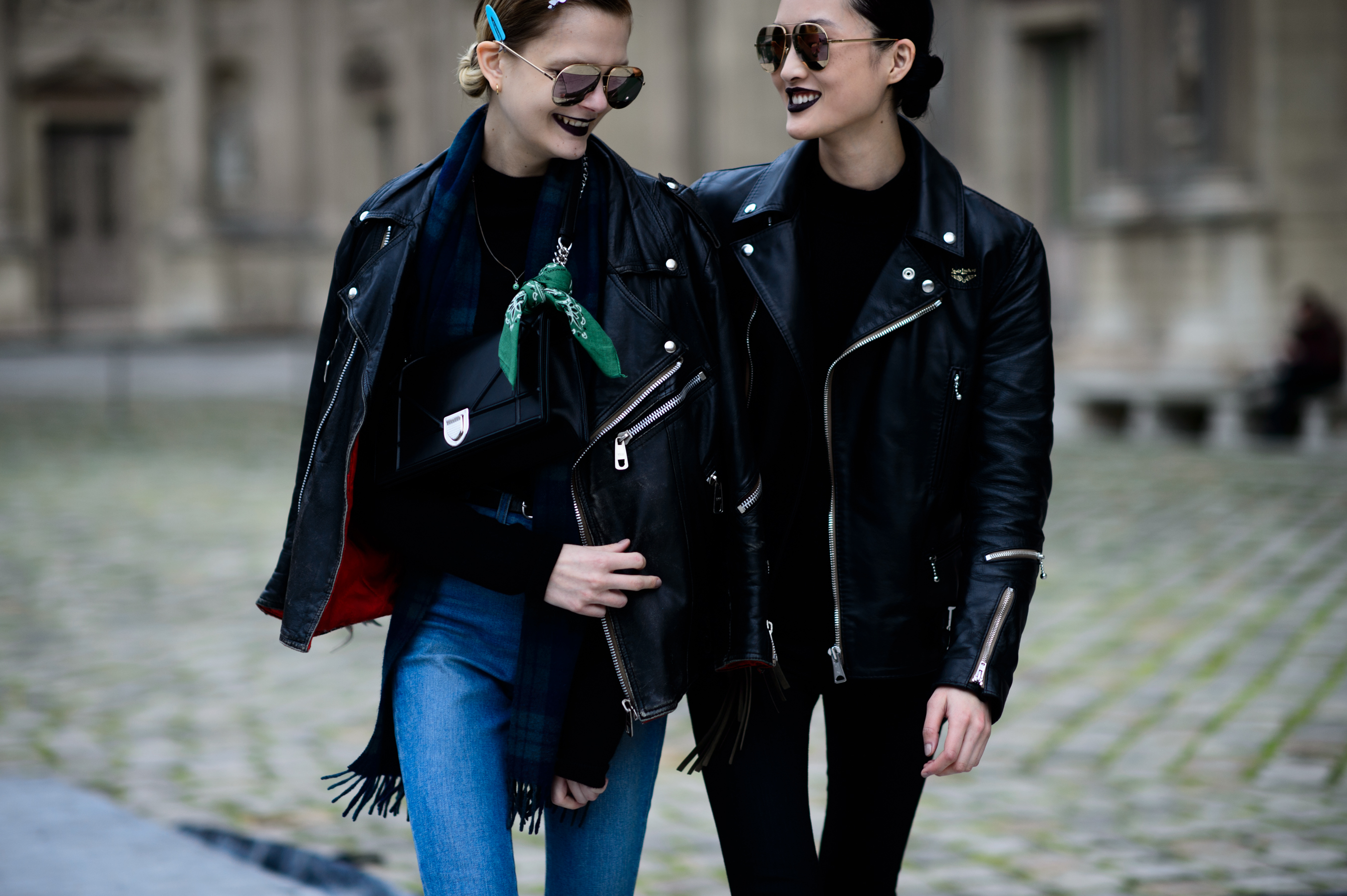 Two models wearing black leather biker jackets