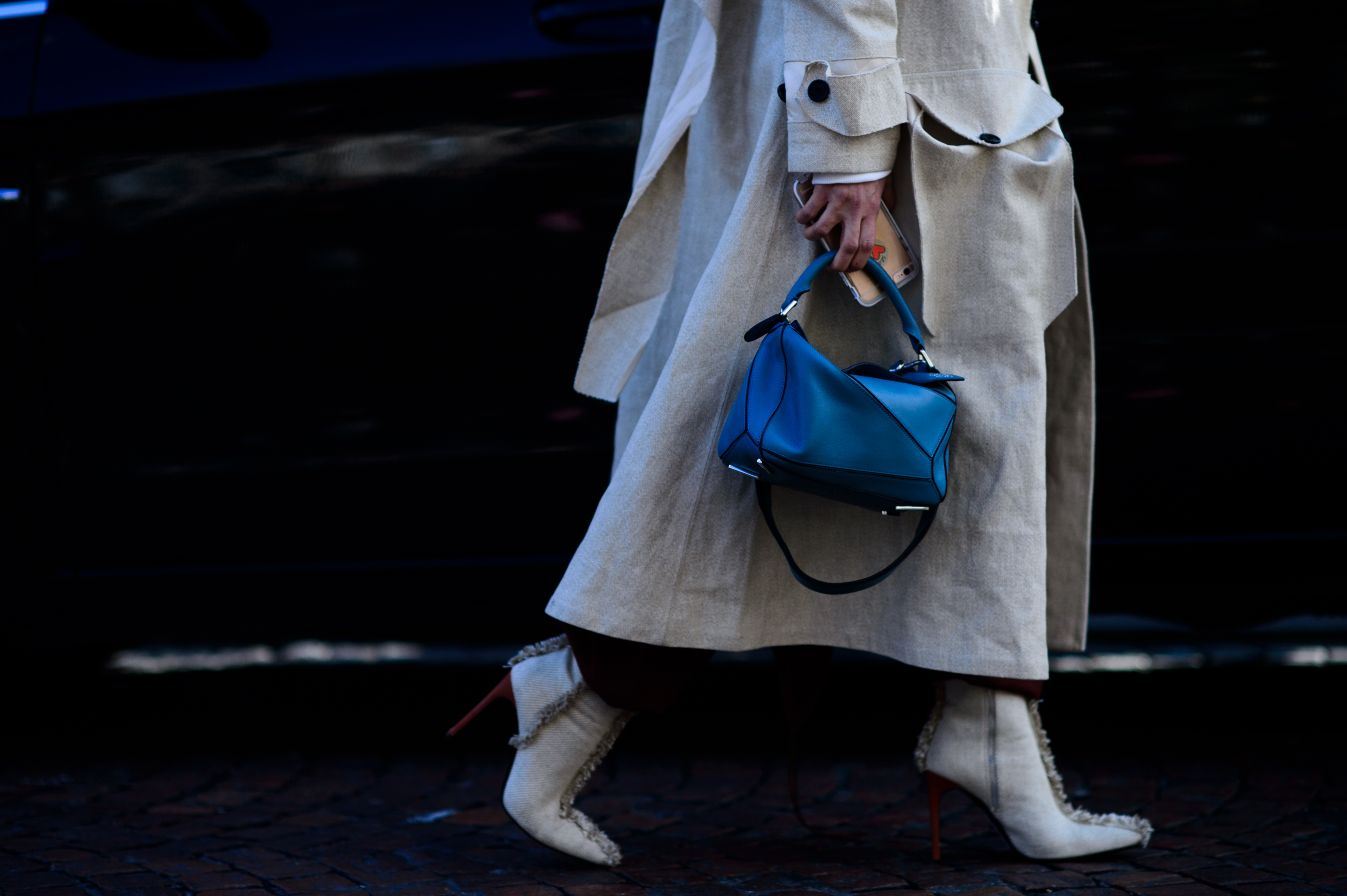 Closeup of woman holding blue bag