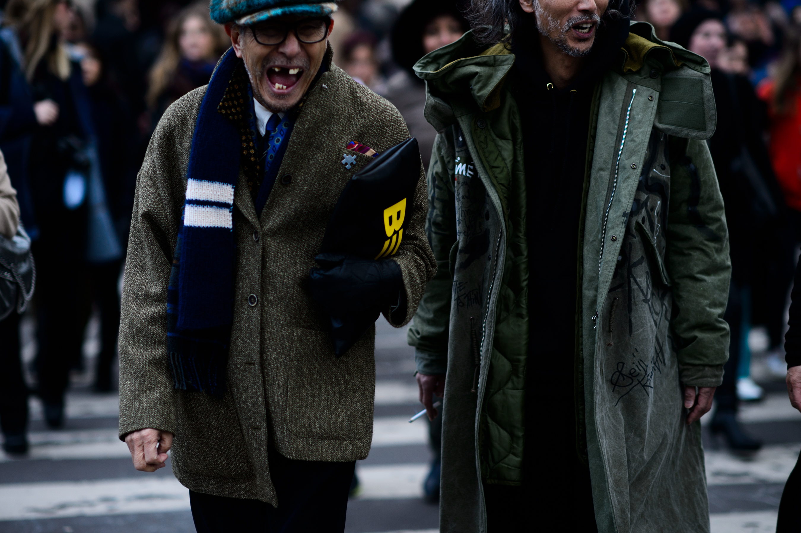 Two mens wearing green coats