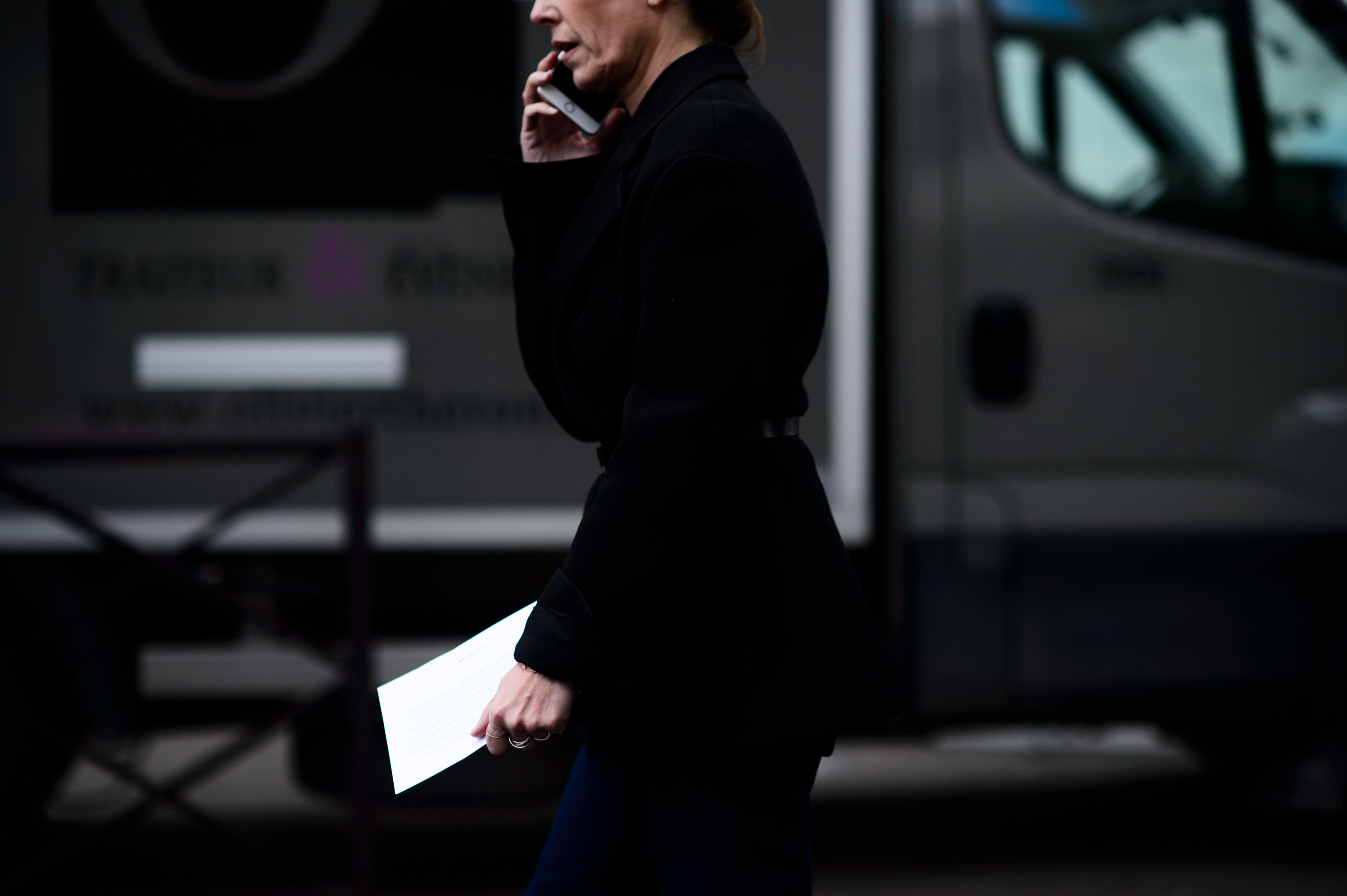 Woman from side in black on phone