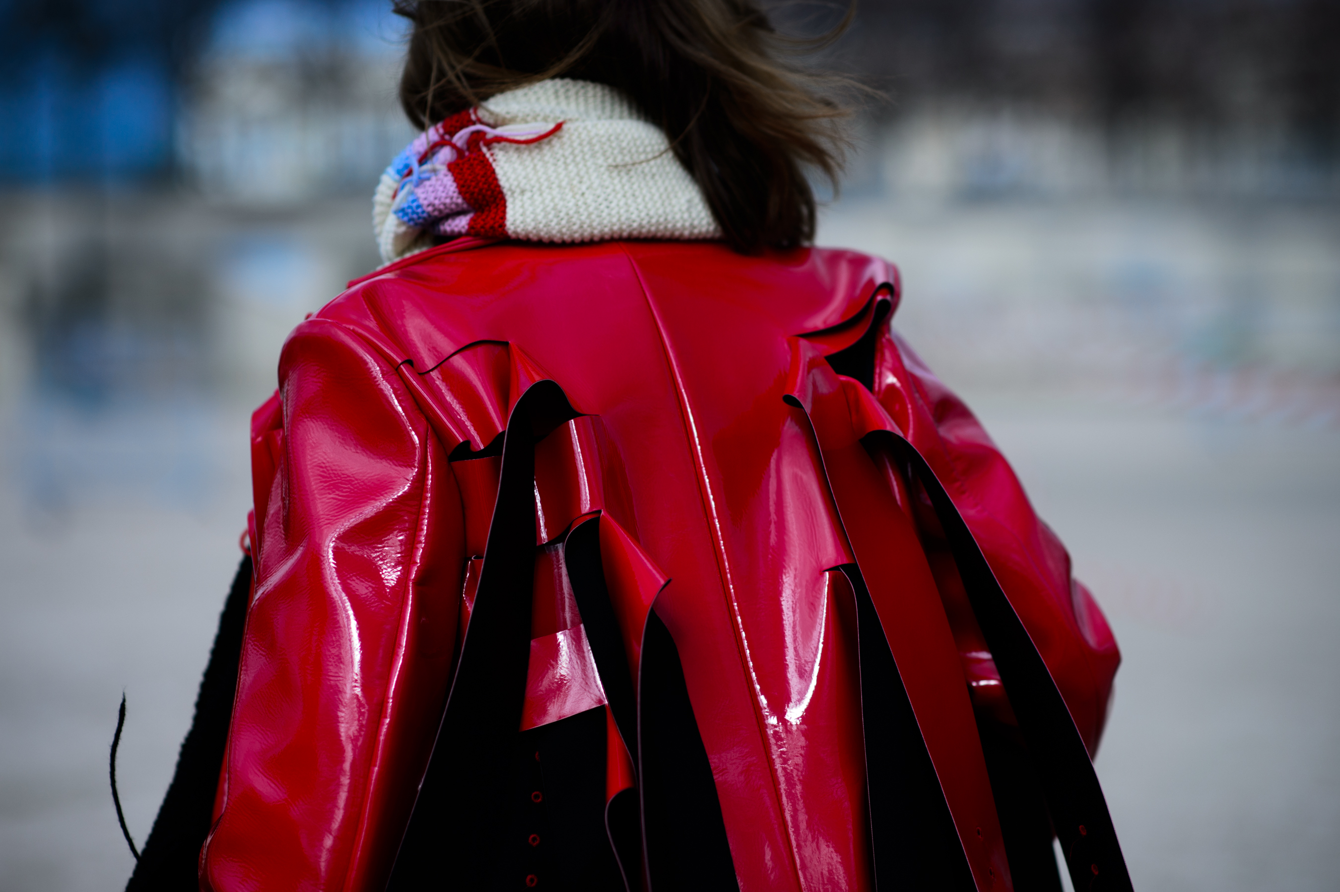 Woman wearing red shiny jacket