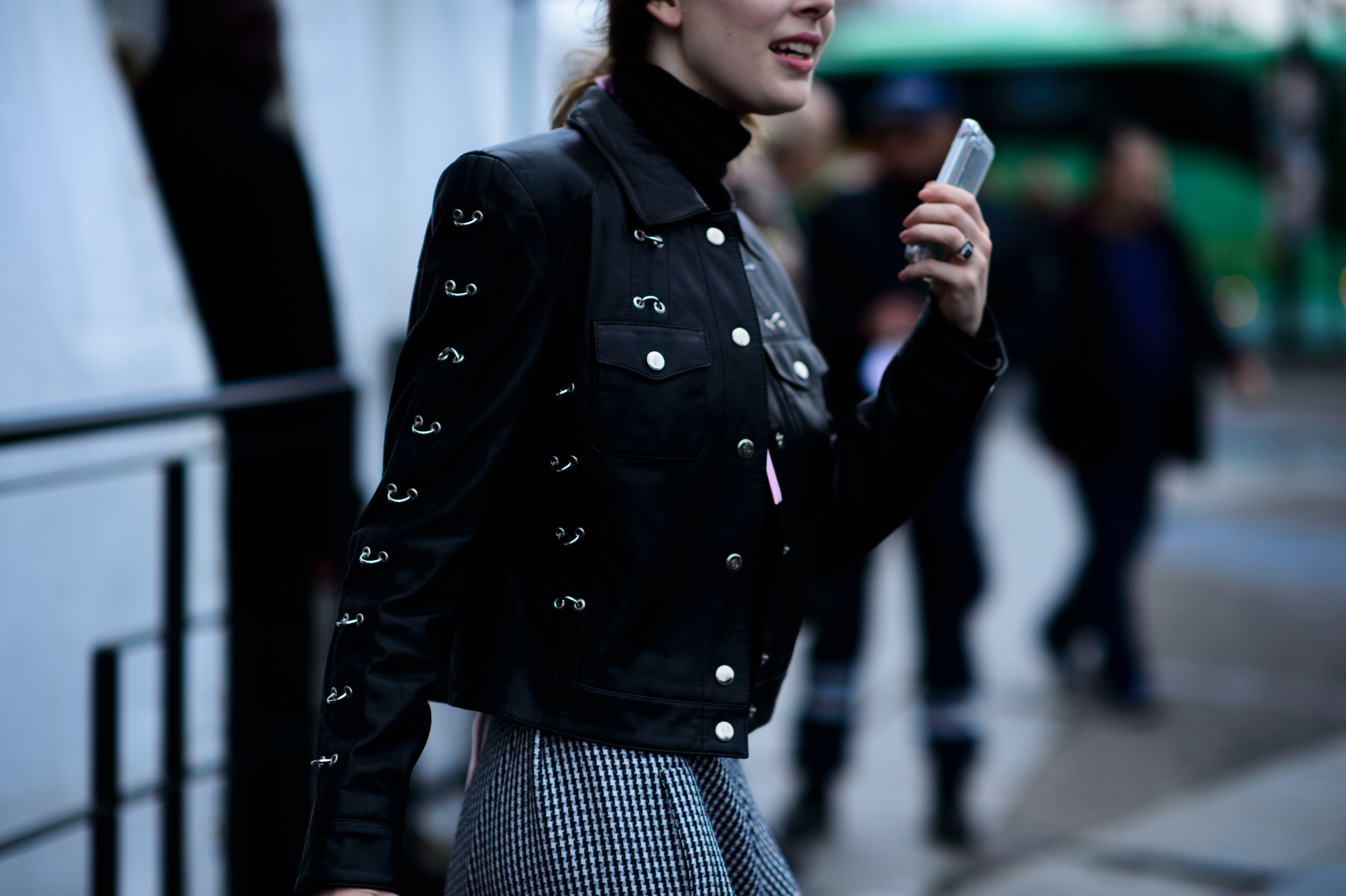 Woman wearing black jacket with silver details