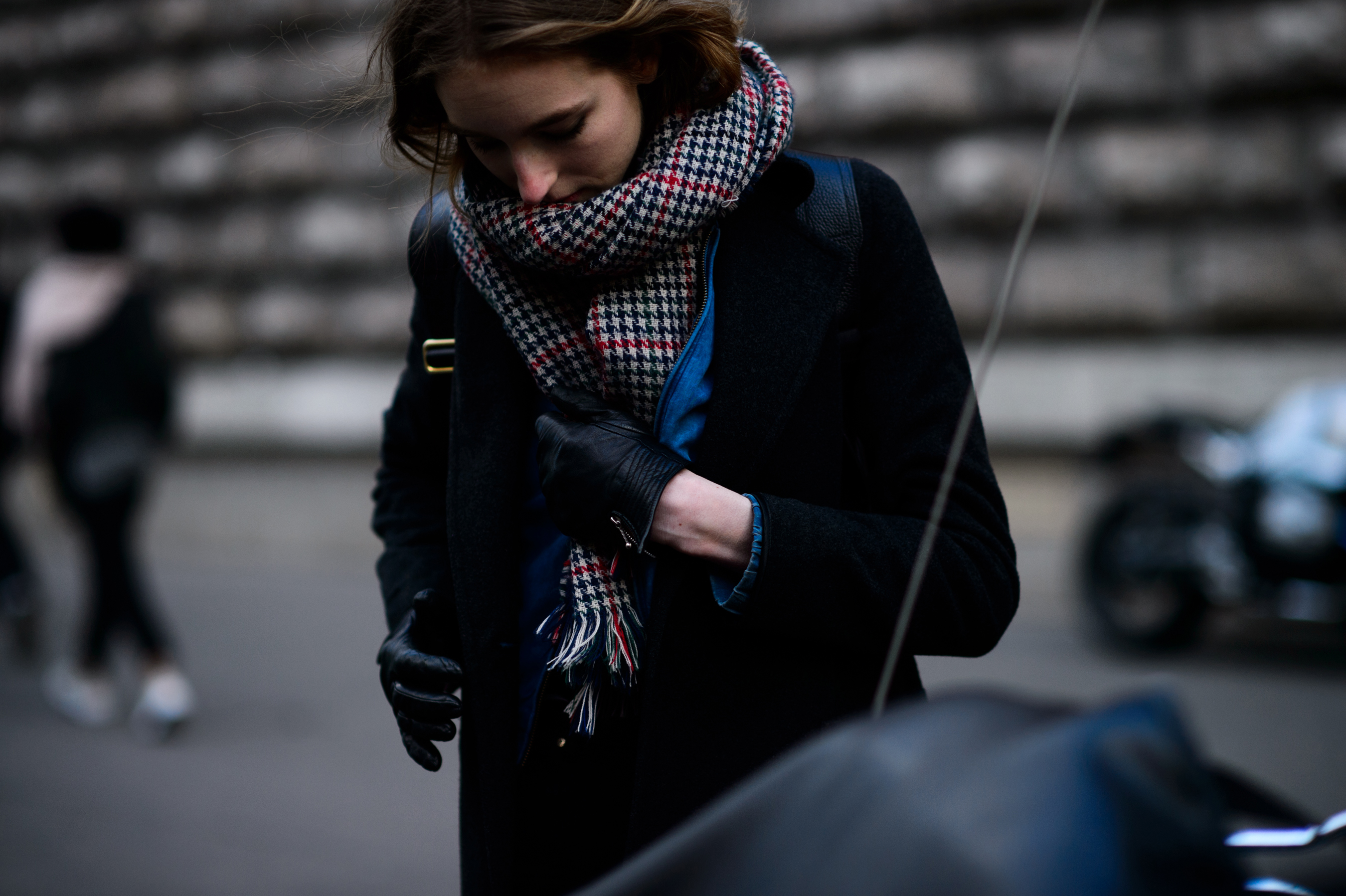 Woman wrapped up in scarf with black gloves