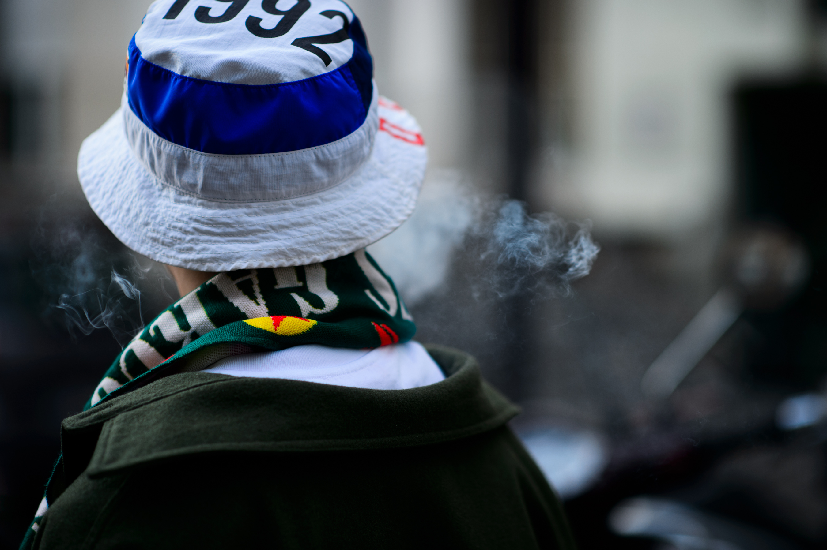 Man wearing scarf and bucket hat