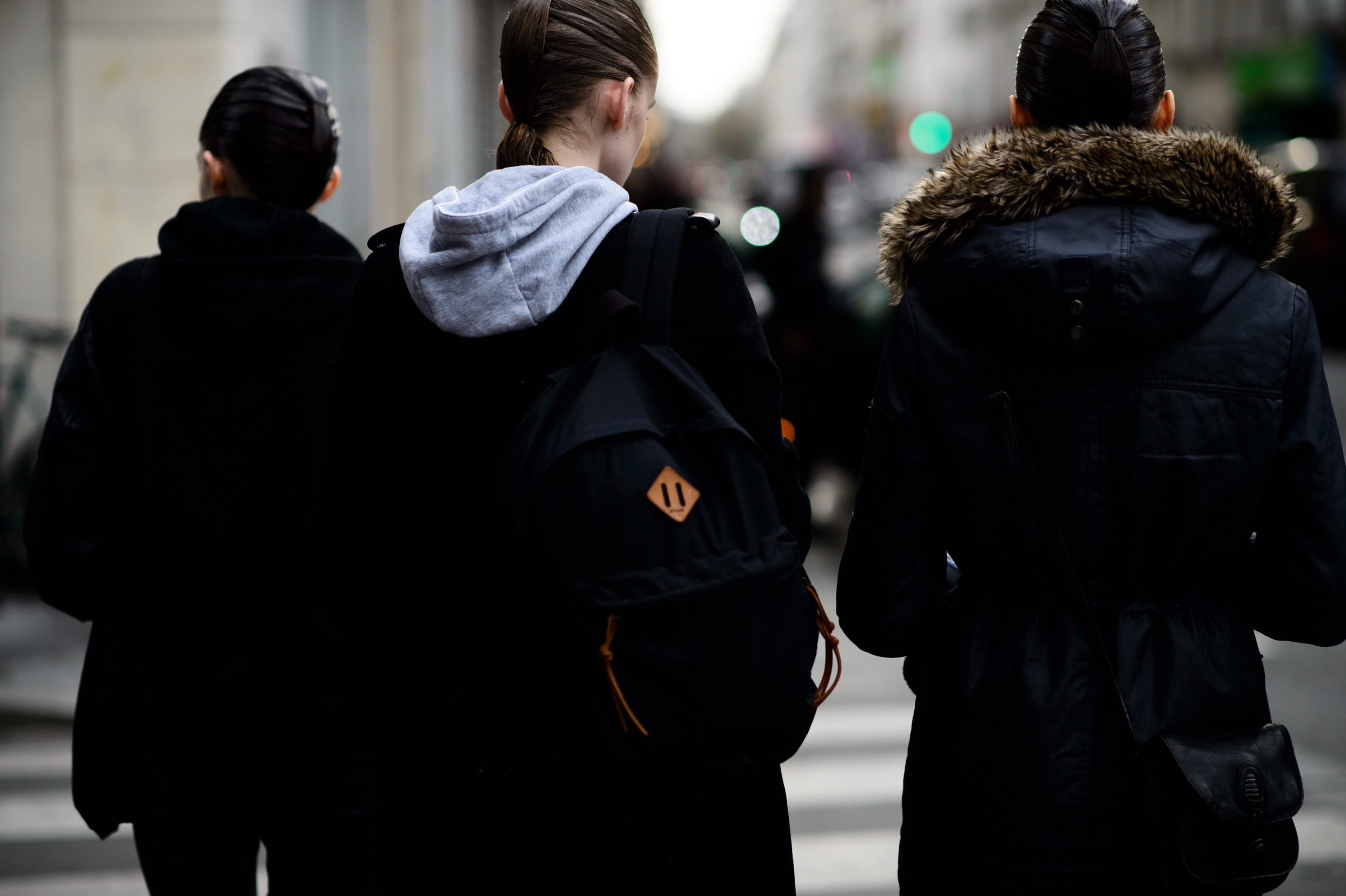 Three models with sleek hair after show