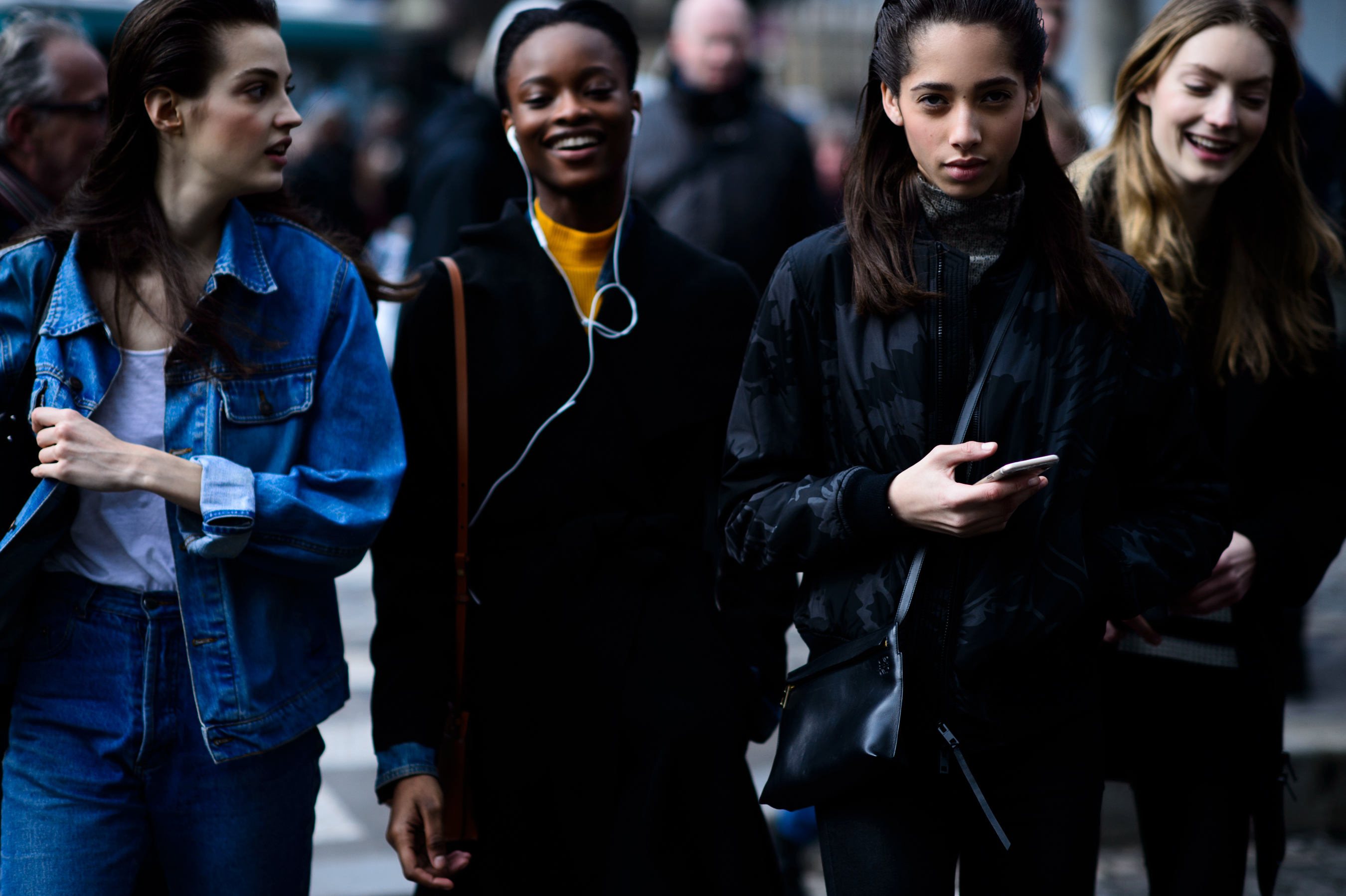 Four models walking in line after show