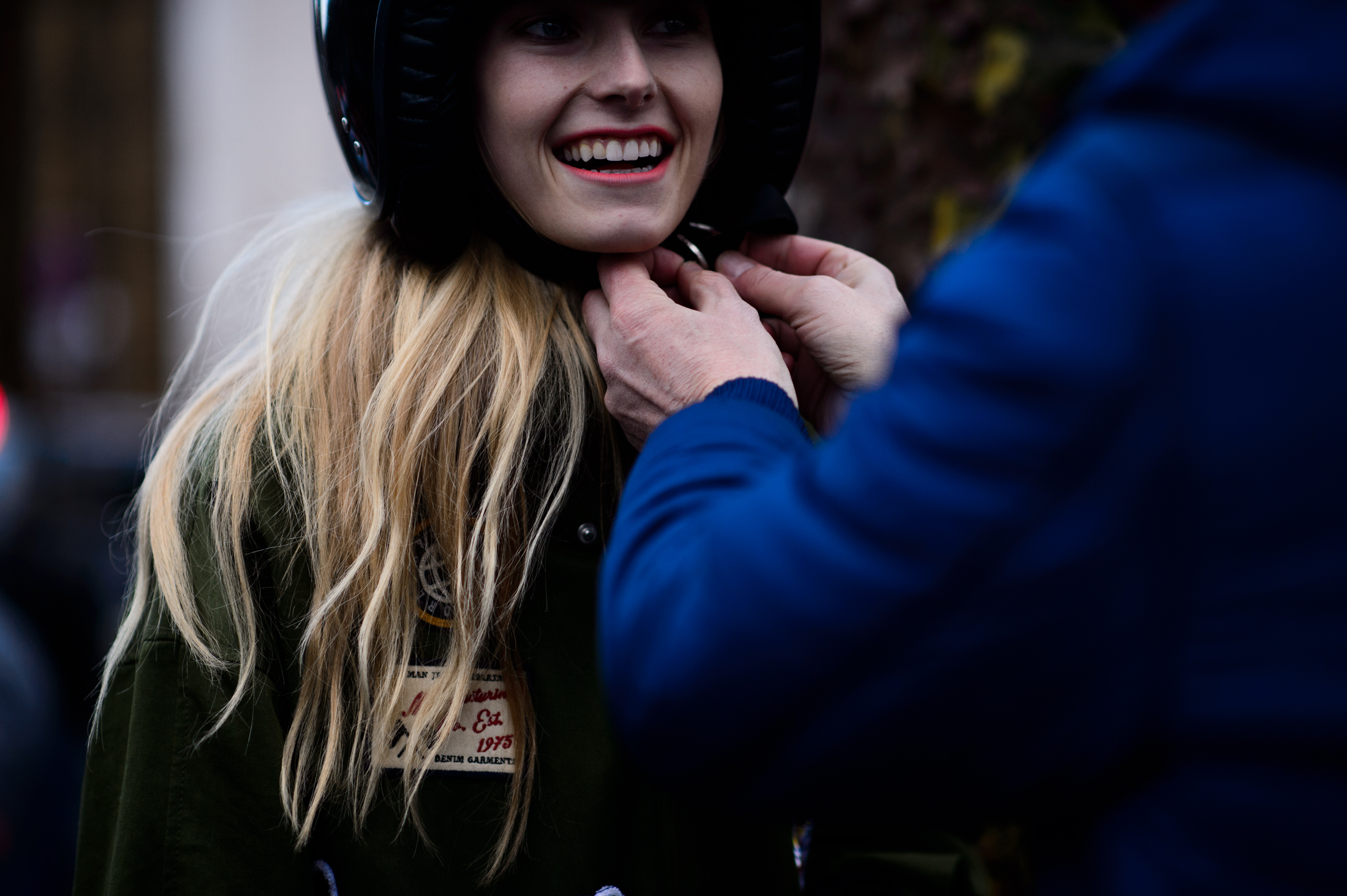 Model with blonde hair wears motorcycle helmet