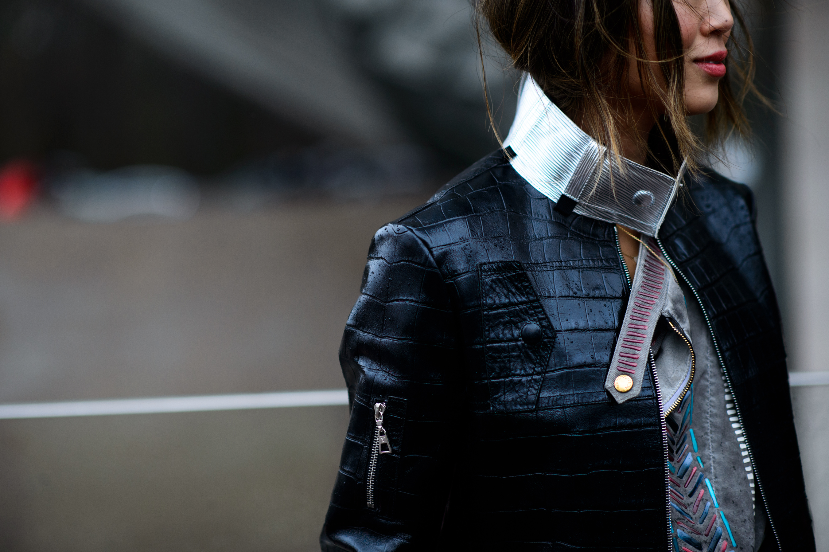 Woman wearing black leather jacket with silver collar