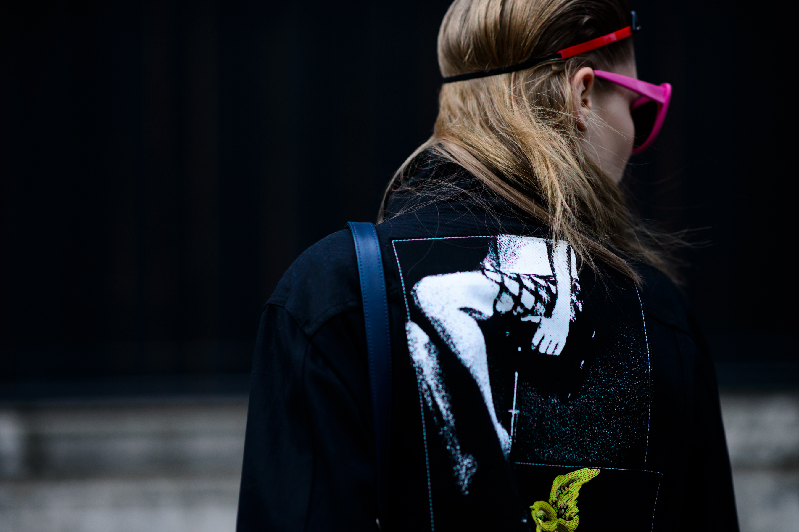 Back of Estonian model wearing black graphic denim