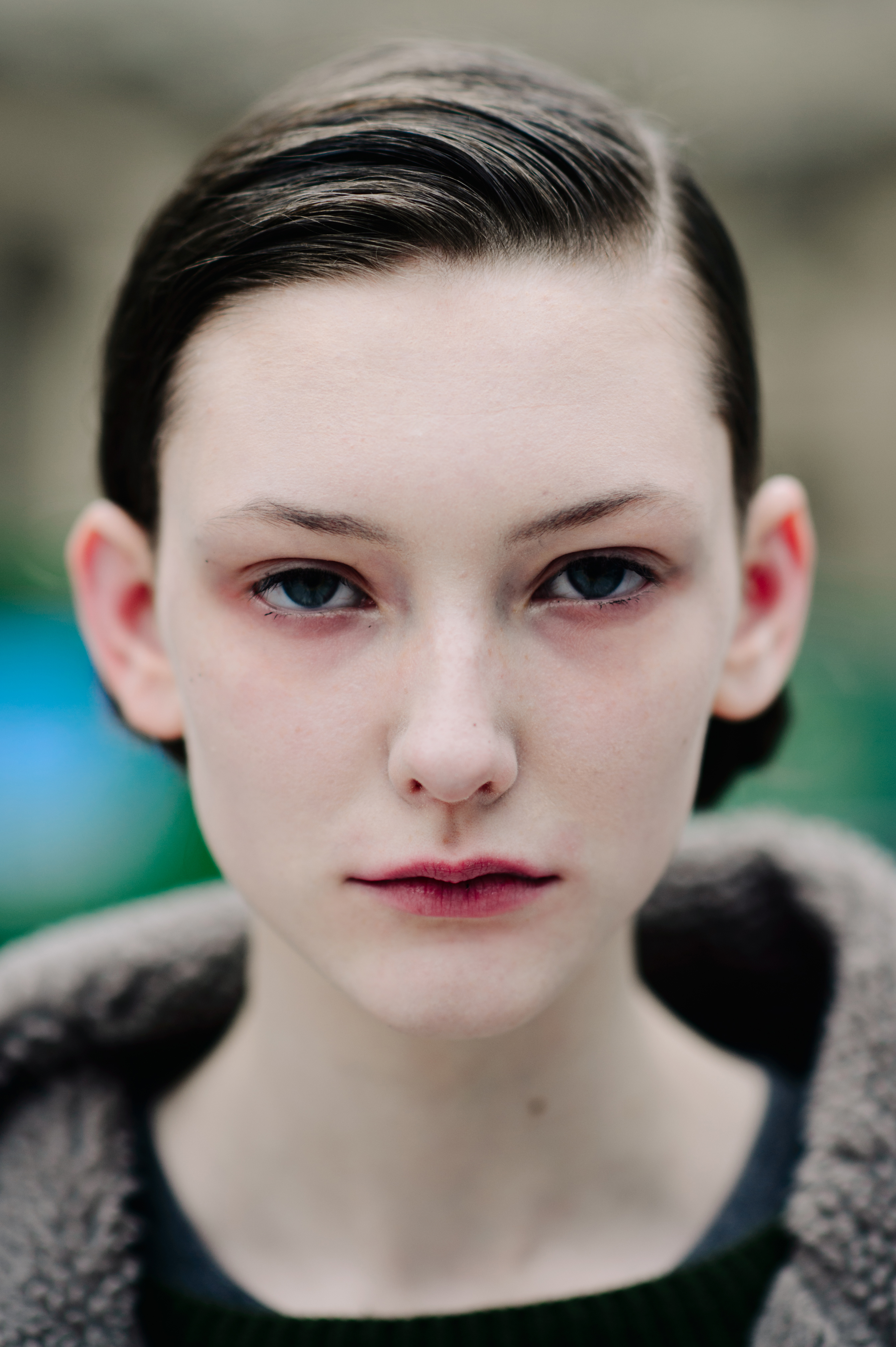 Portrait of model with tied hair and blue eyes