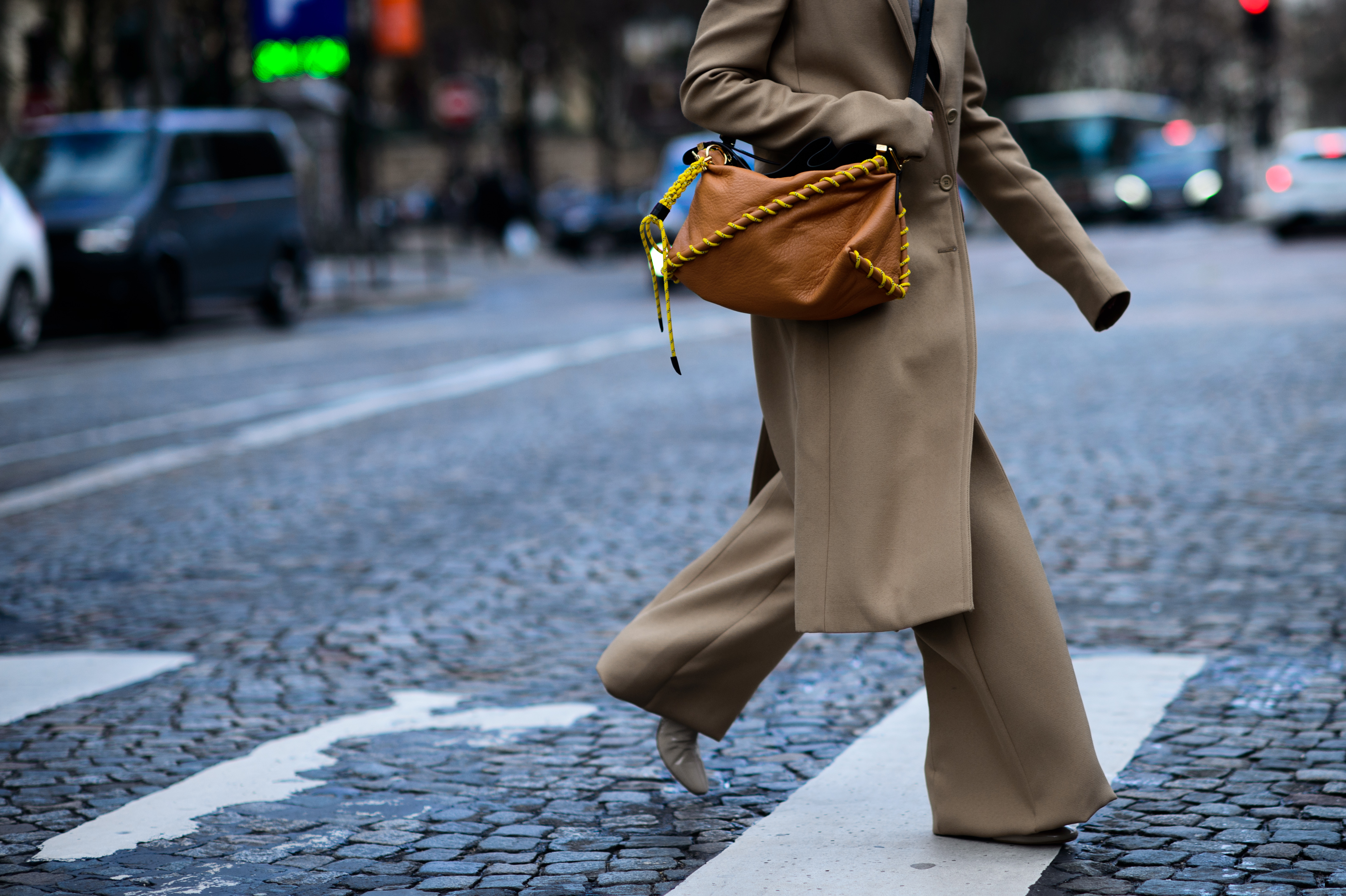 Woman wearing camel colour coat and trousers