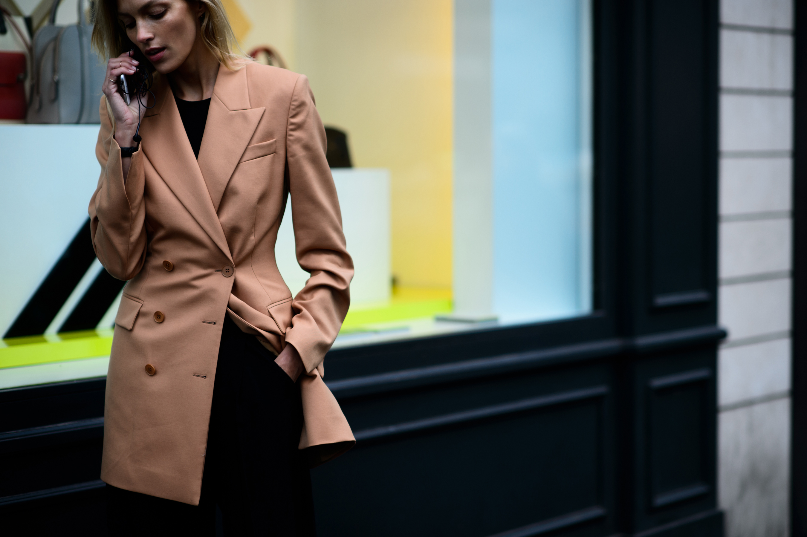 Polish model on phone with hand in pocket