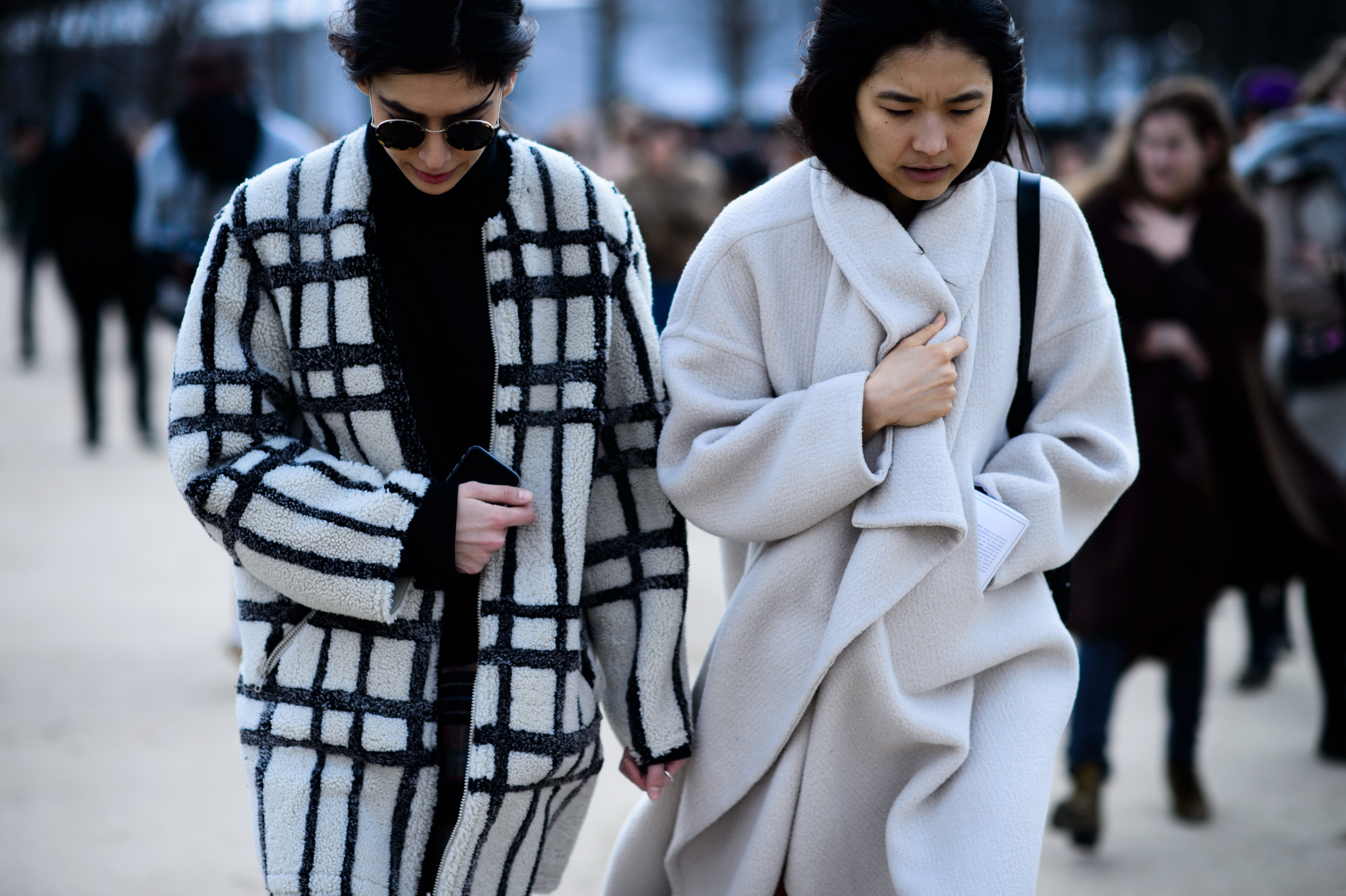 Two women wearing grey wool coats after show