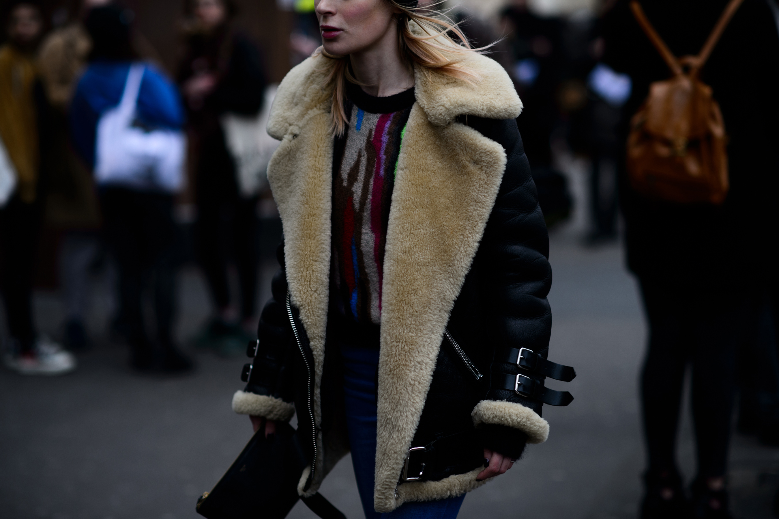 Woman wearing brown shearling trim jacket