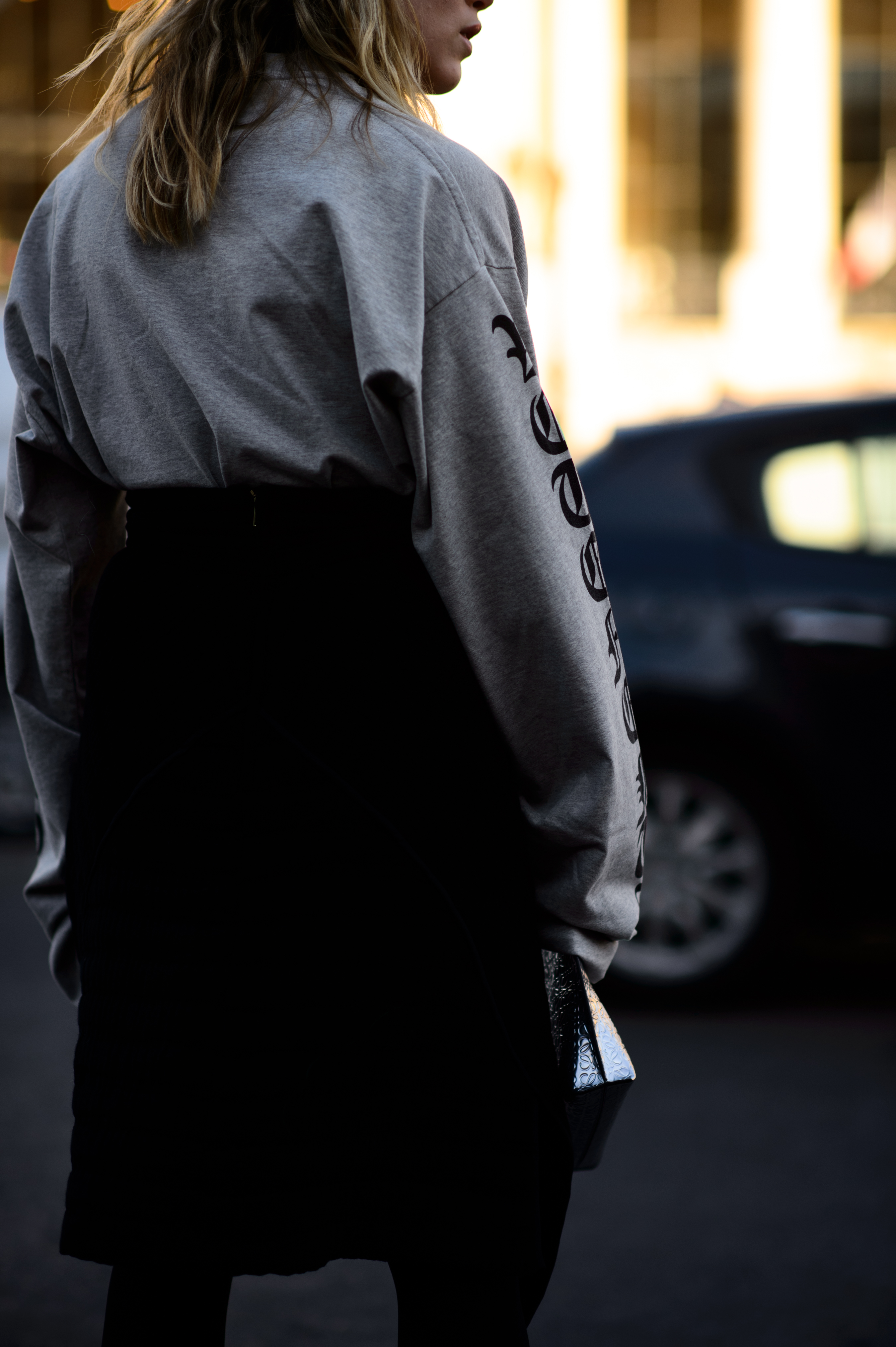 Woman wearing grey tee shirt with black arm print