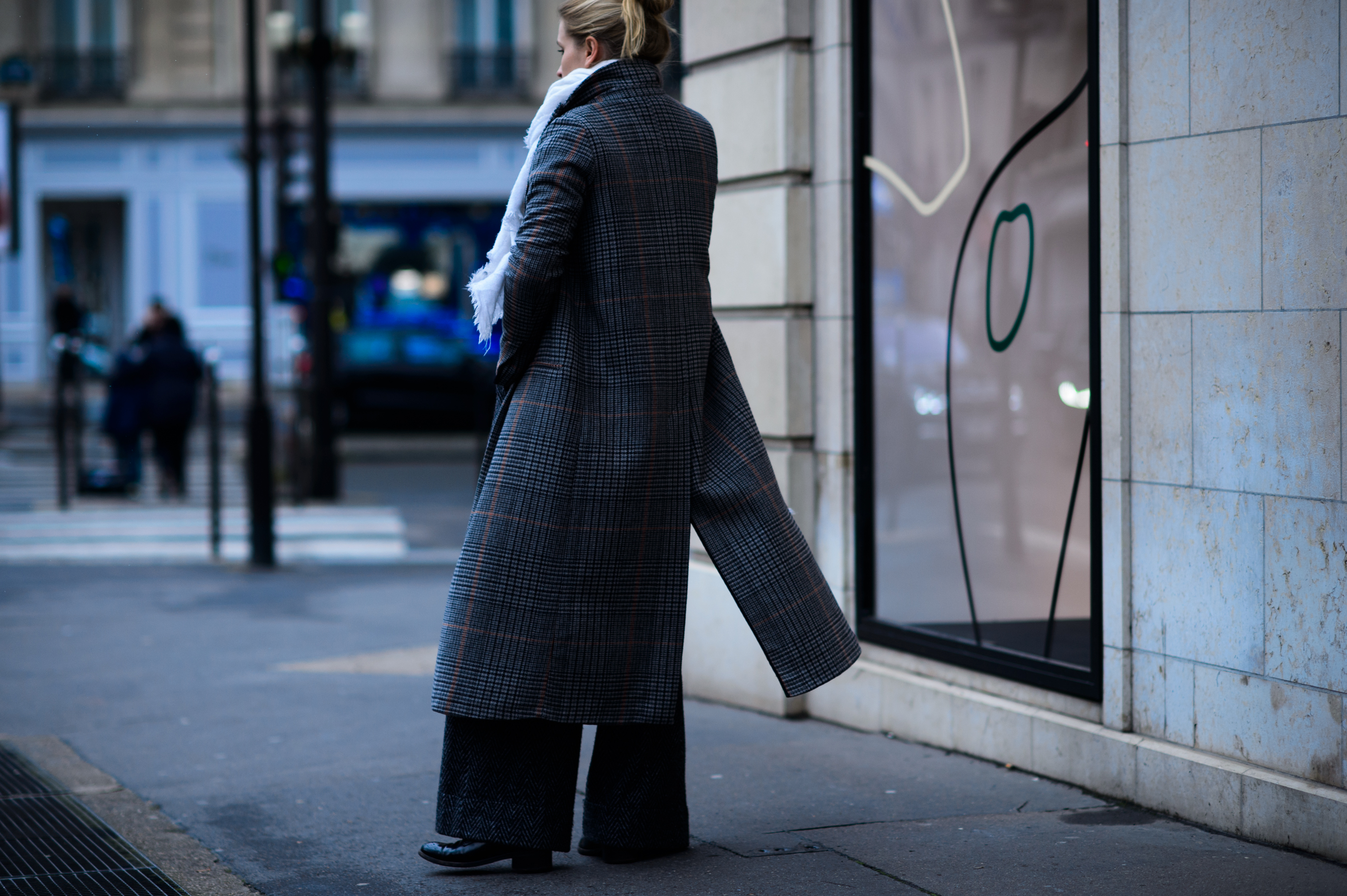 Woman wearing long check coat from rear