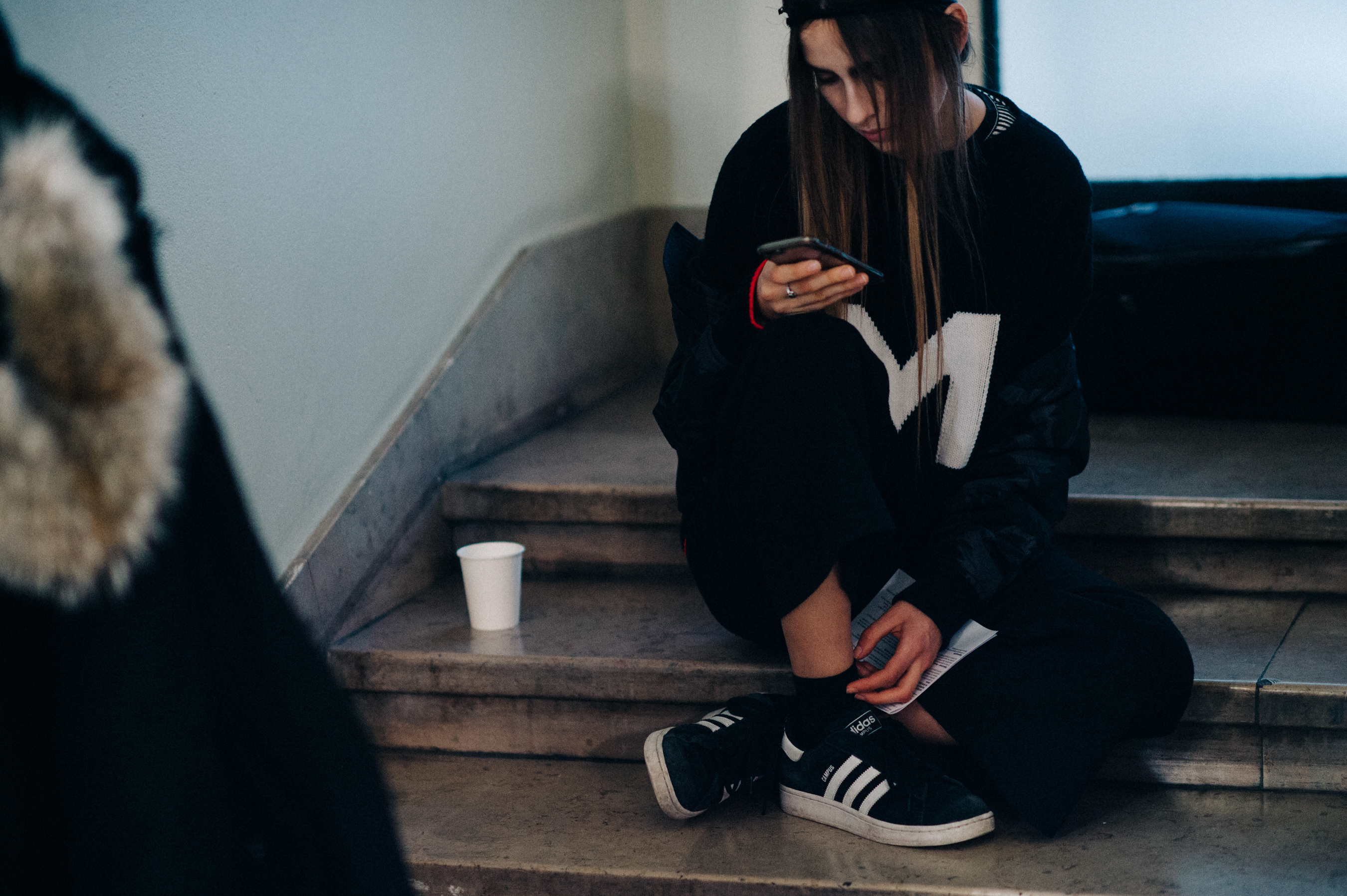 Brazilian model sat backstage on phone