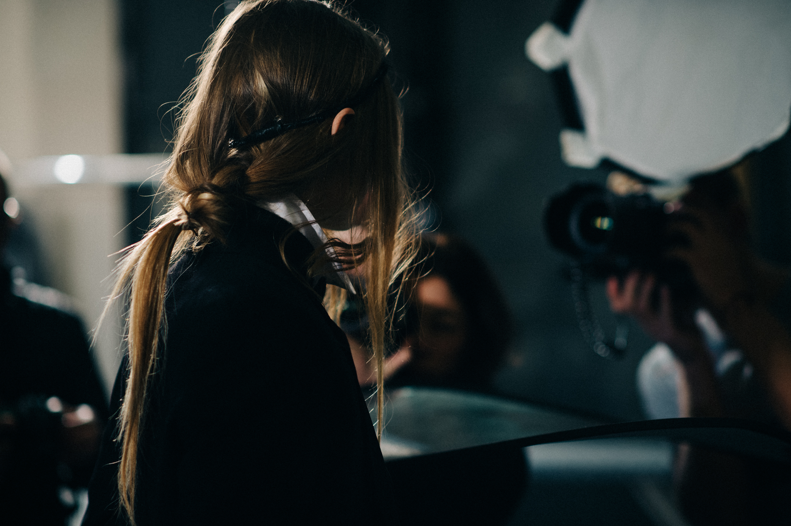Back of models head with messy ponytail