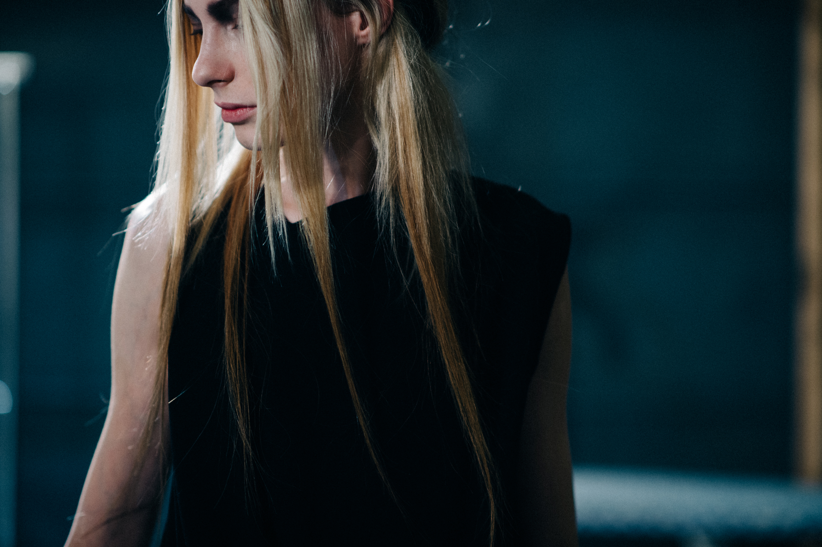 Model with long blonde hair and black dress