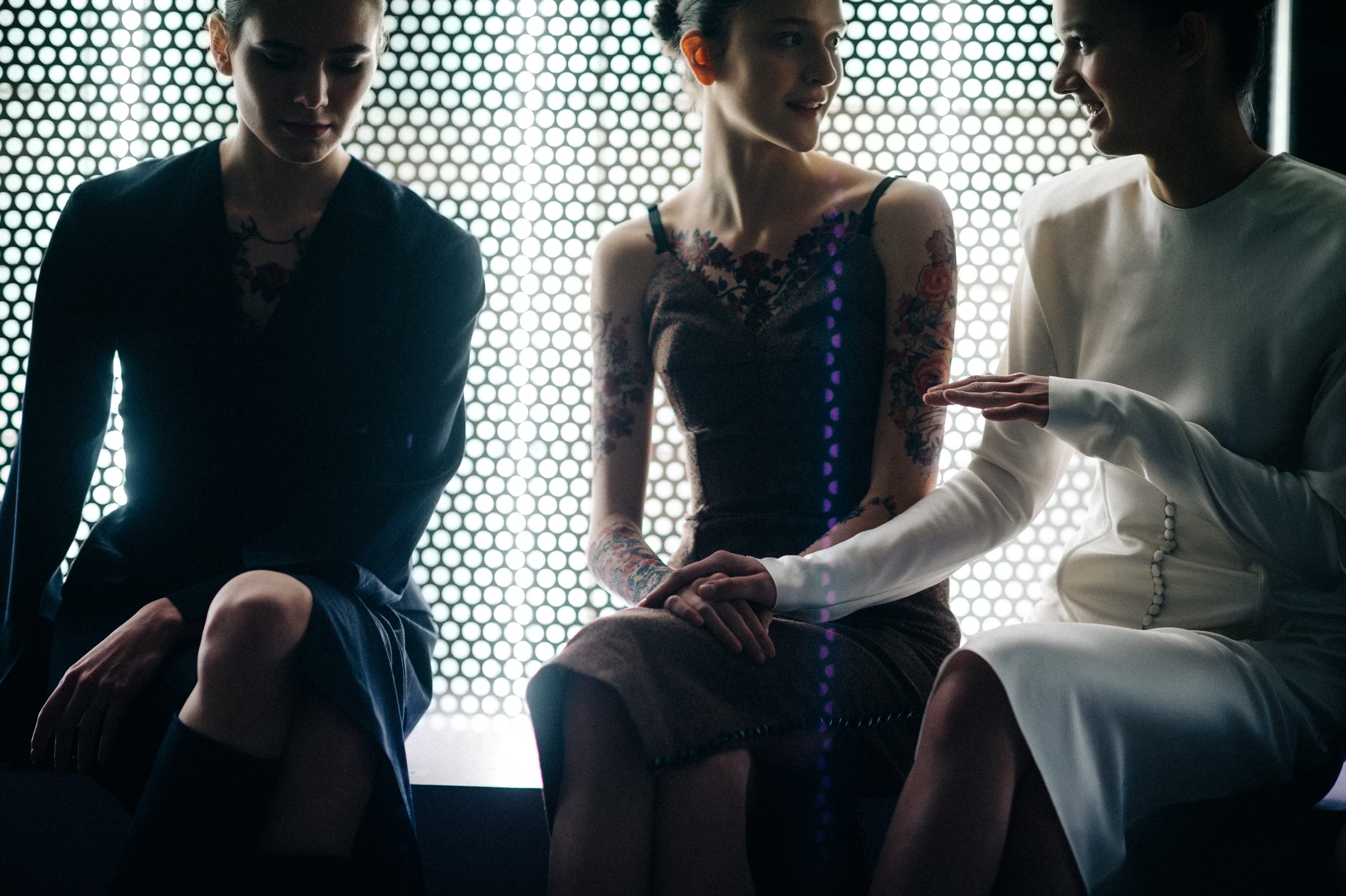 Three models socialising before the show
