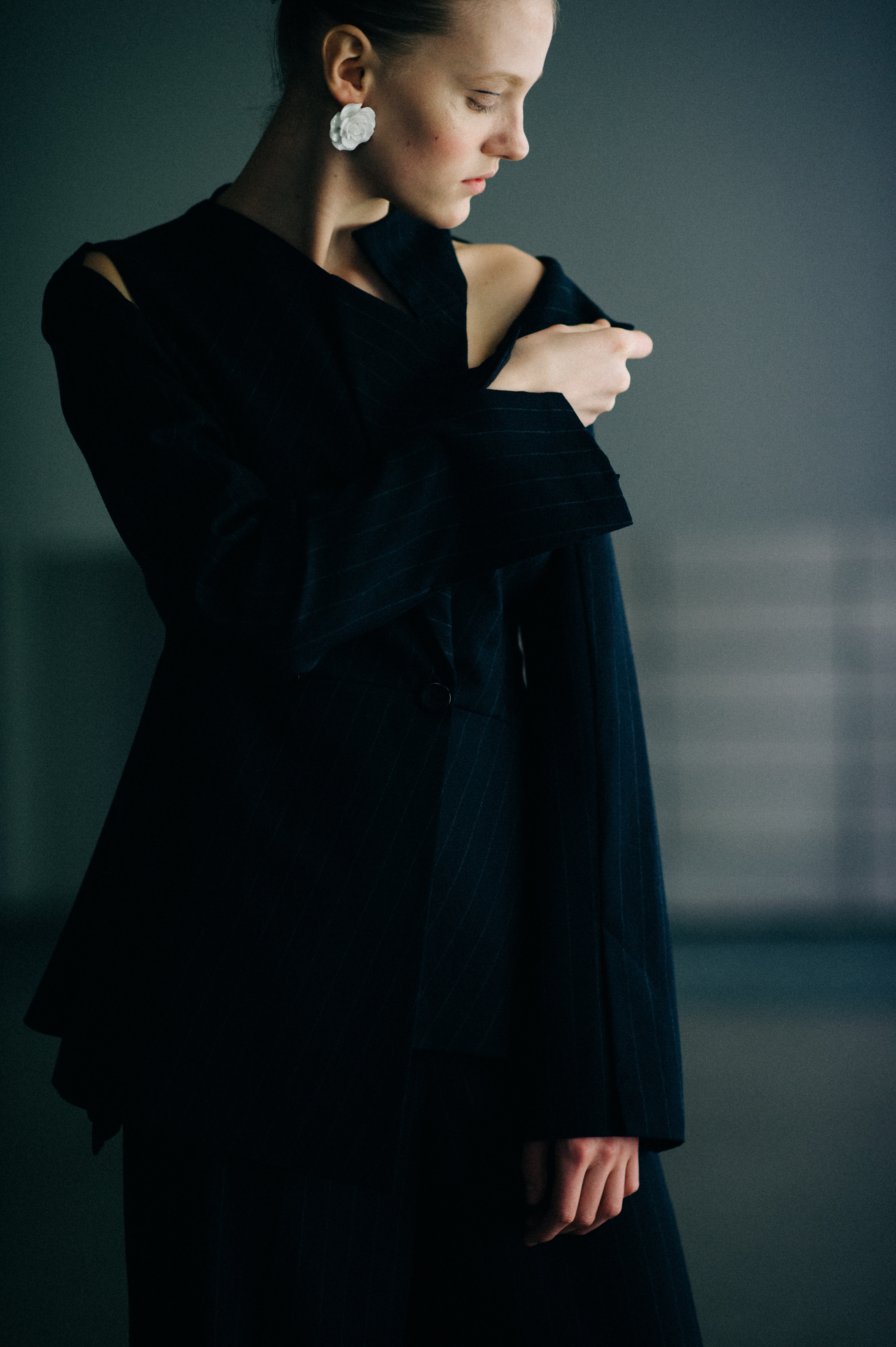 Model wearing black deconstructed suit