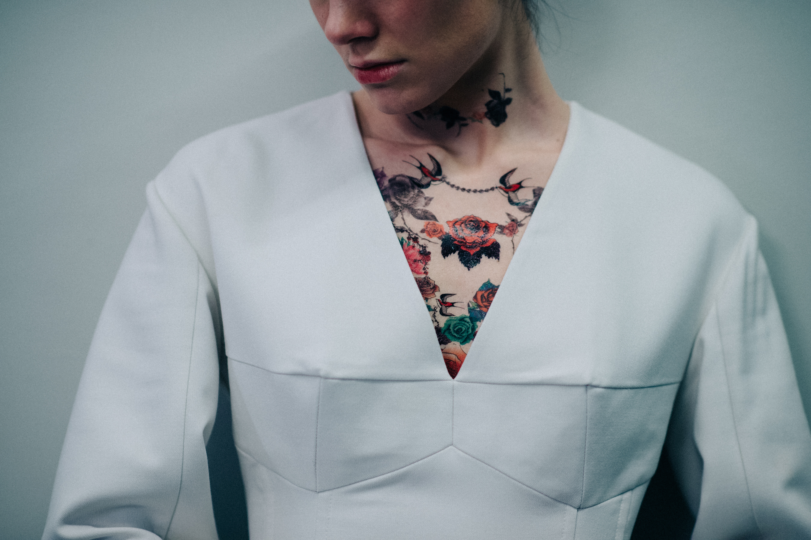 Model wearing white dress fake tattoos