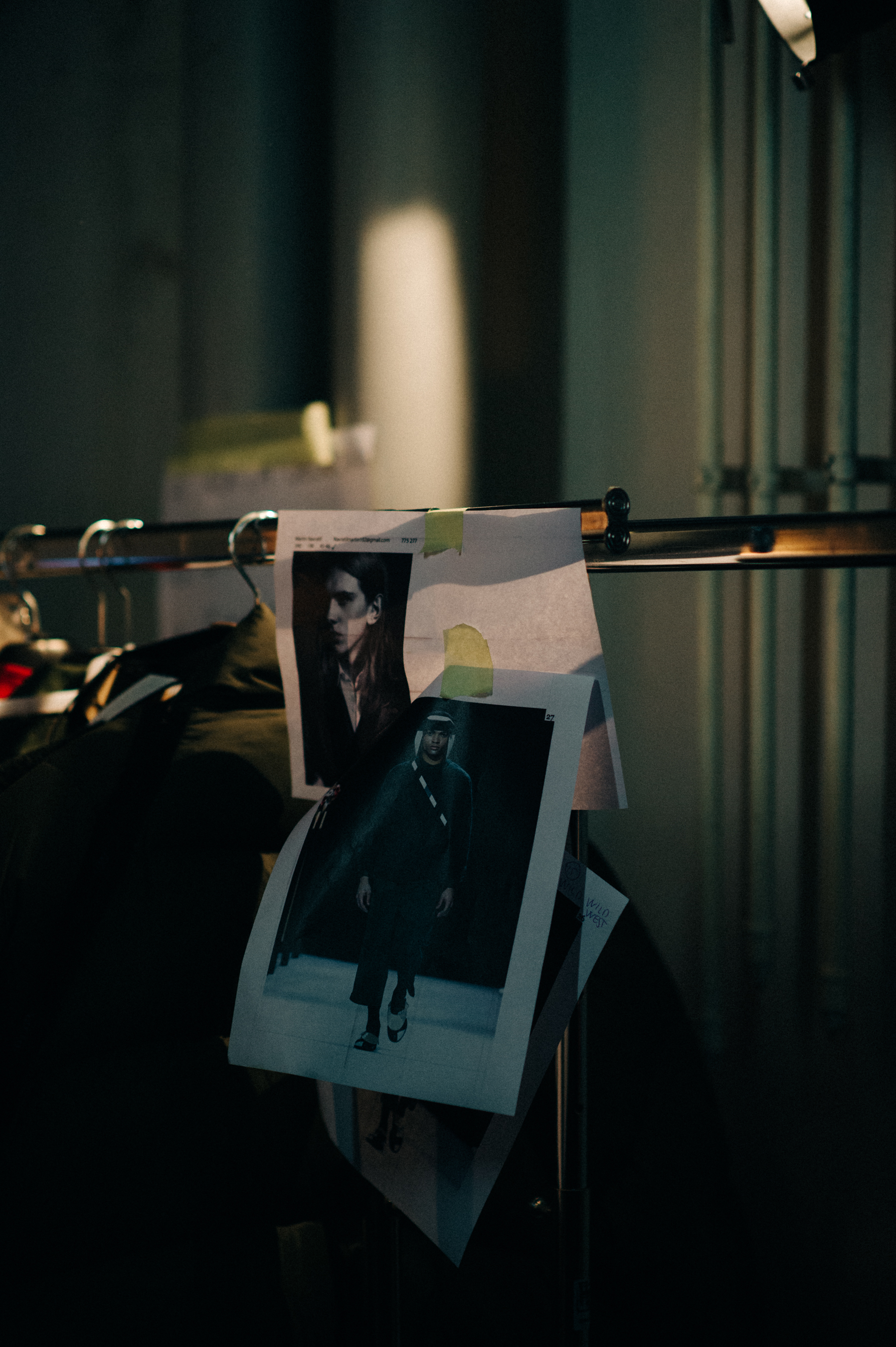 Rail with model polaroid before show
