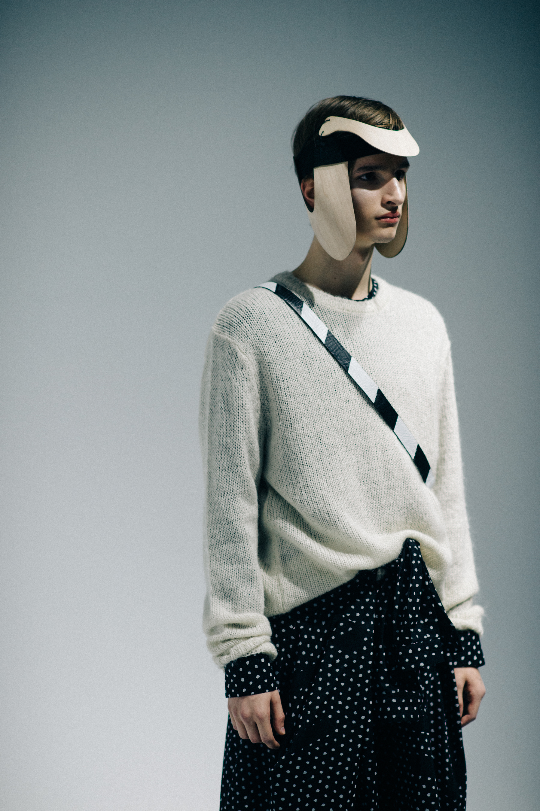 Male model wearing white sweater