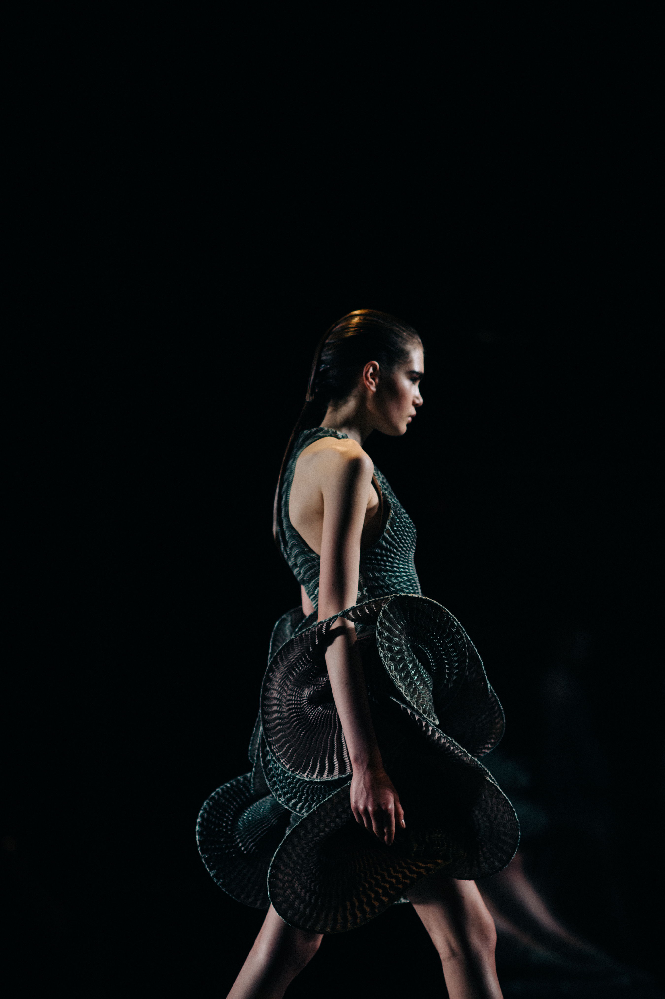 Model wearing complex fabric dress