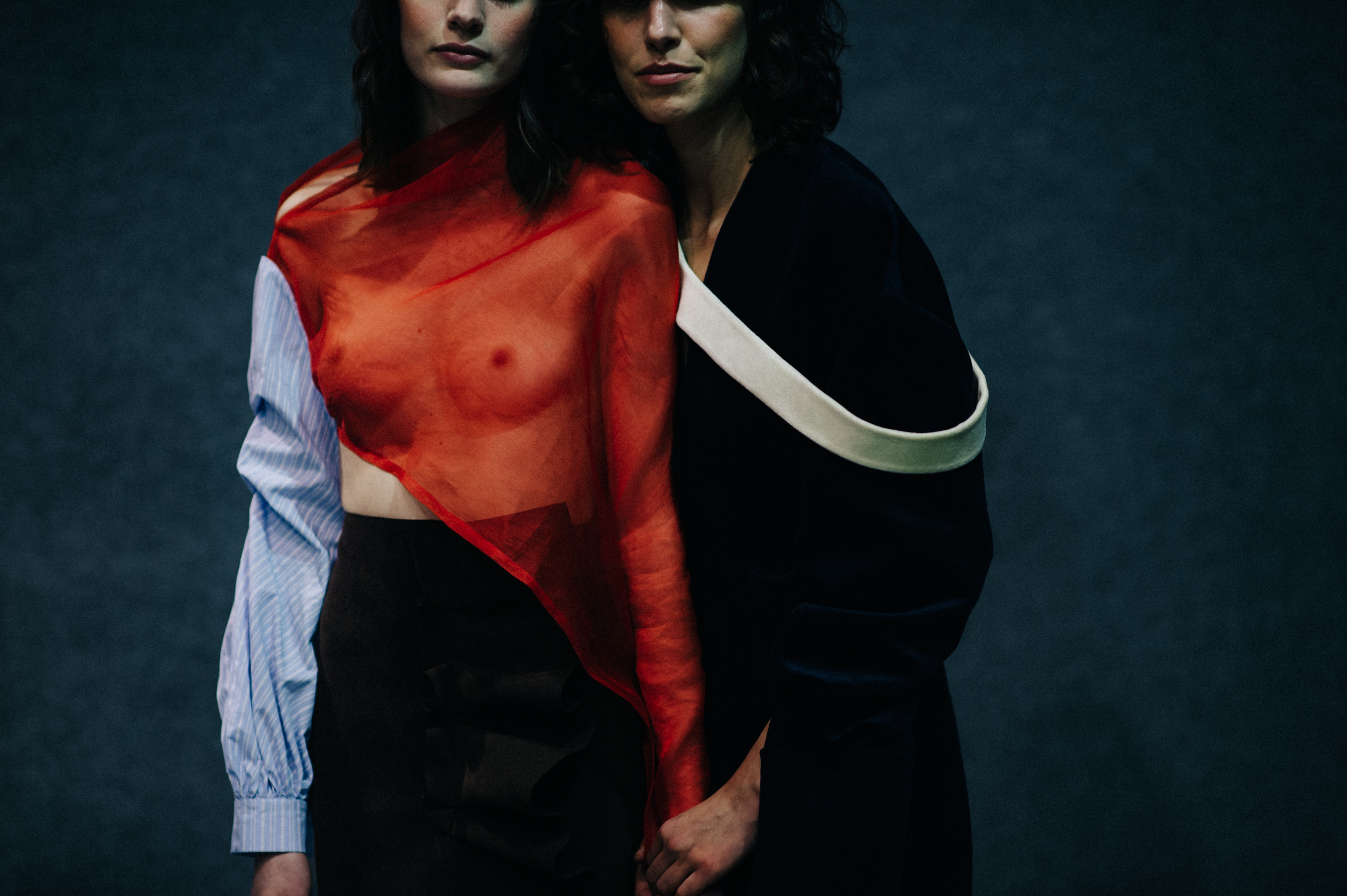 Two models holding hands wearing red
