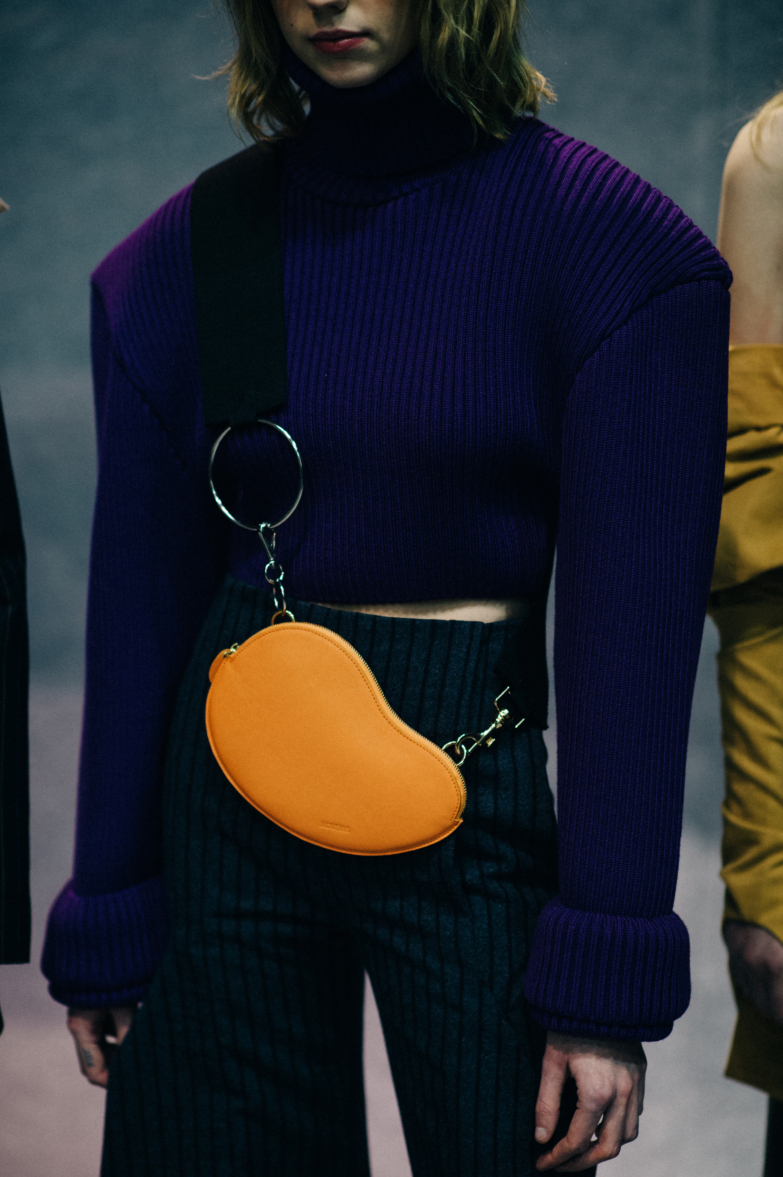 Model wearing orange bag