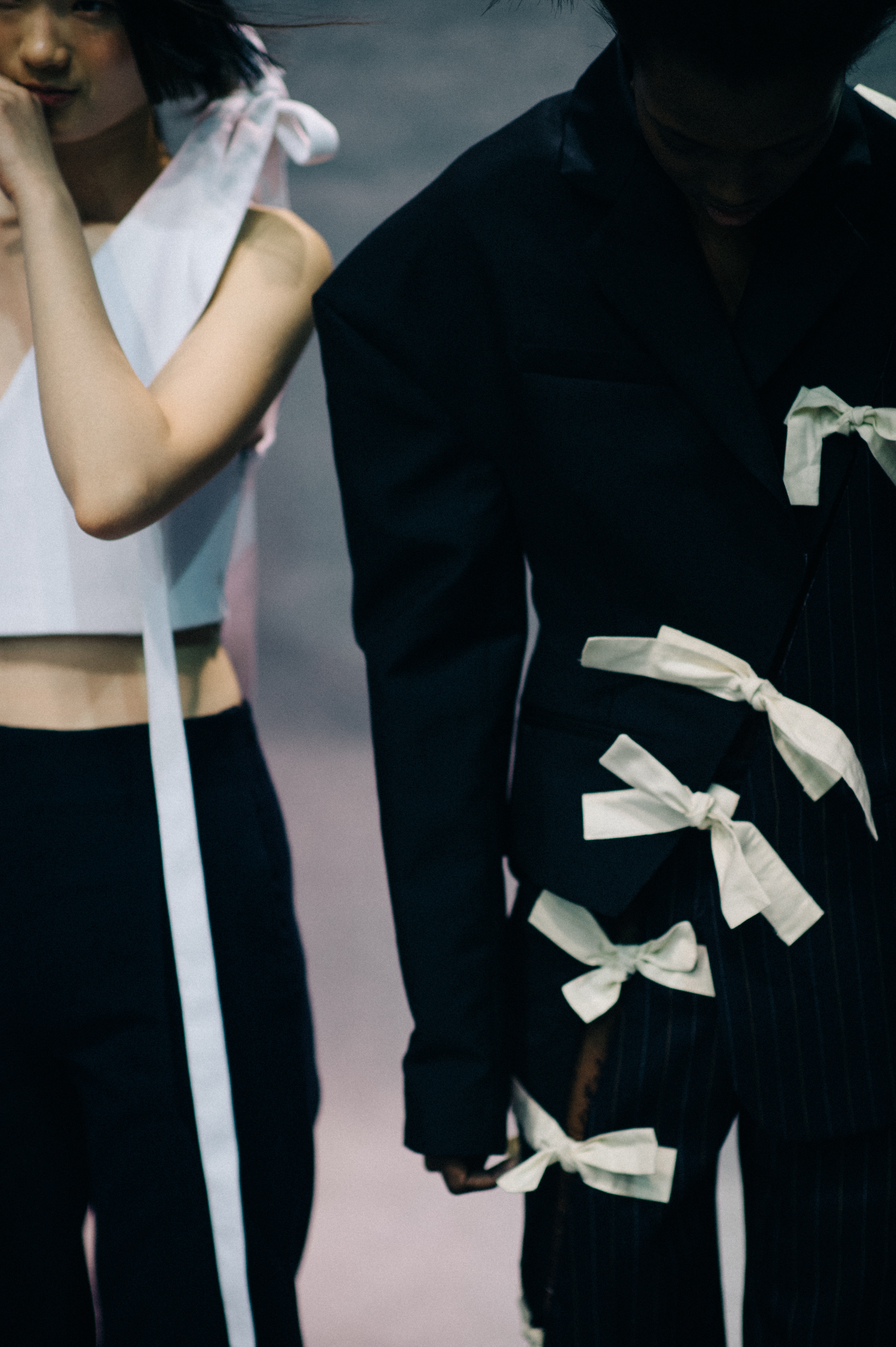 Models wearing bows backstage
