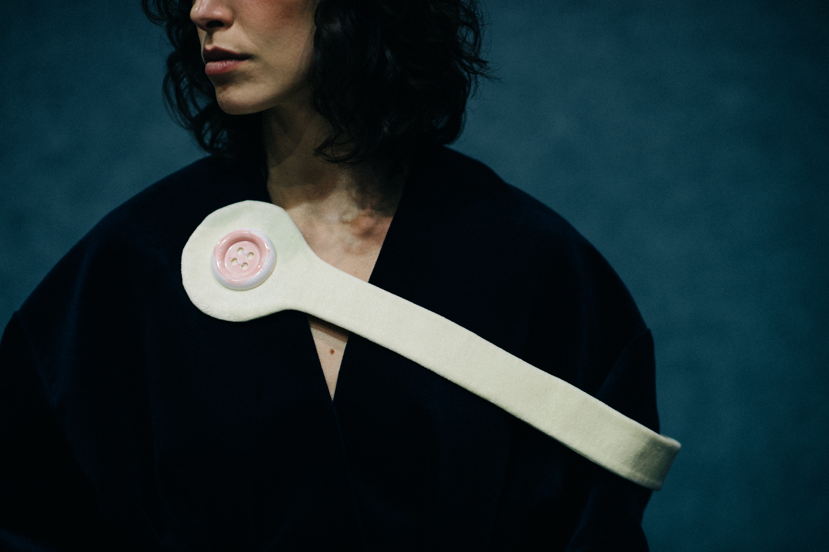 Model with oversized button detail