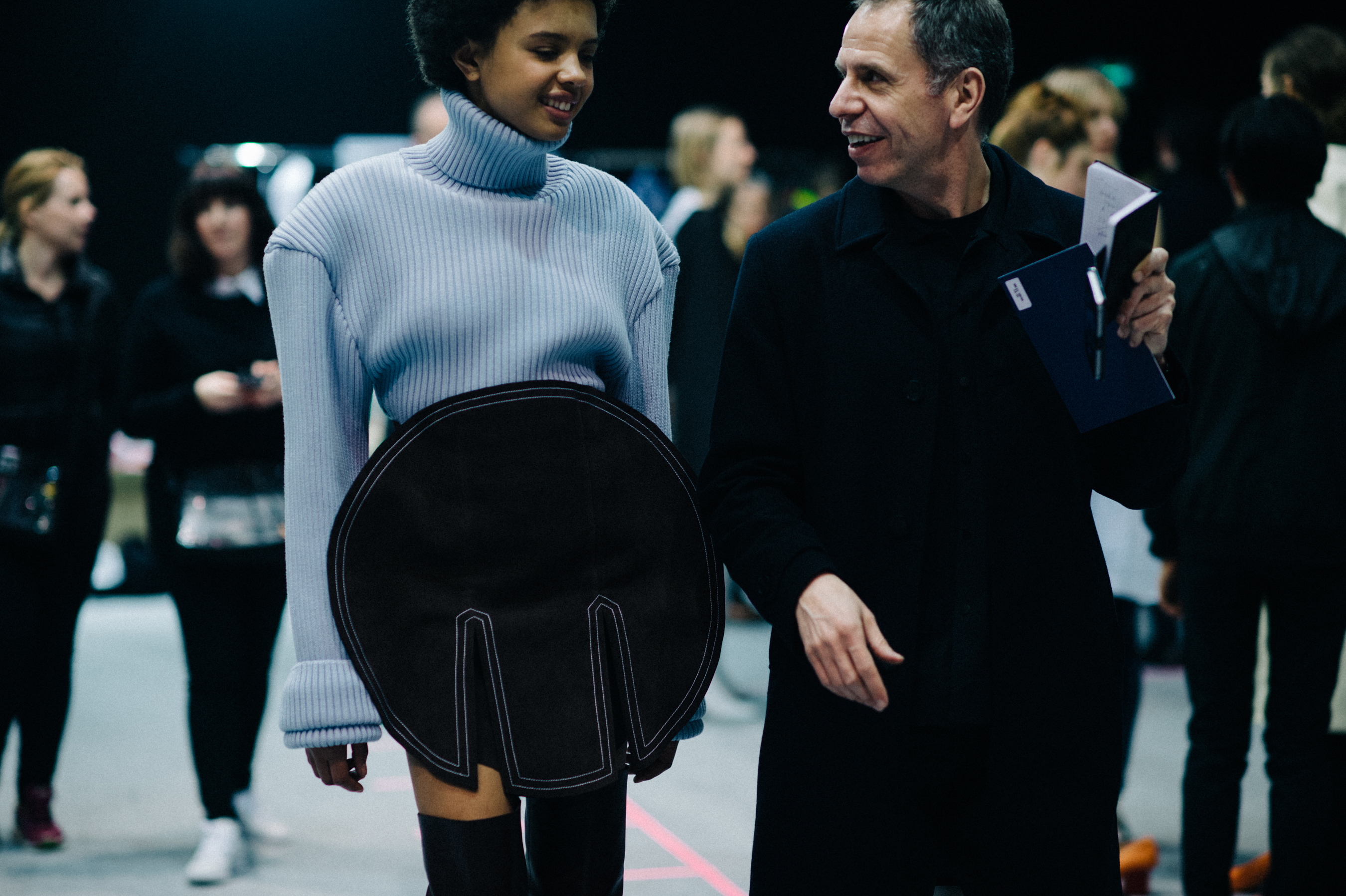 Model wears blue turtleneck before show