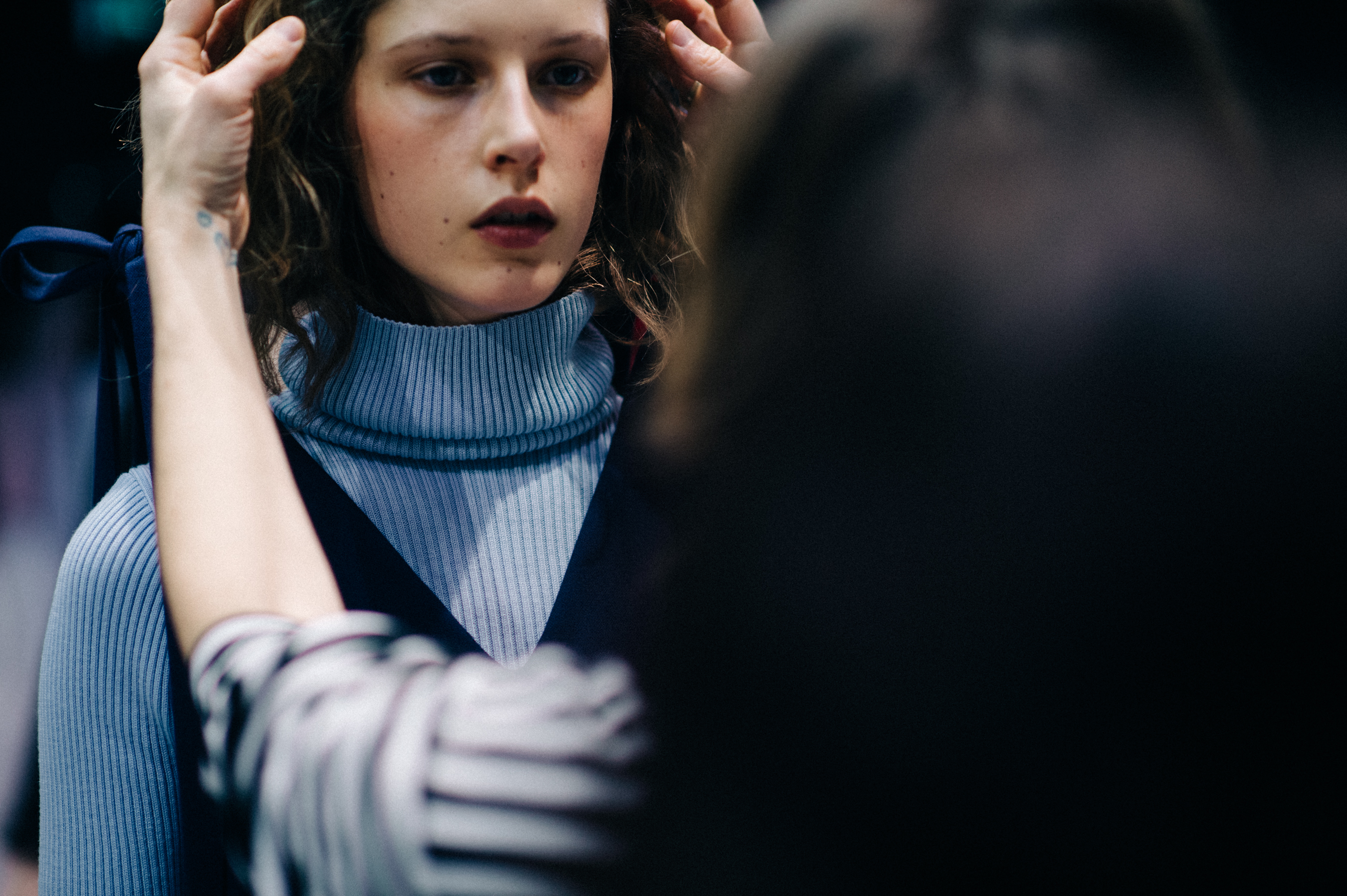 Model having hair done before show