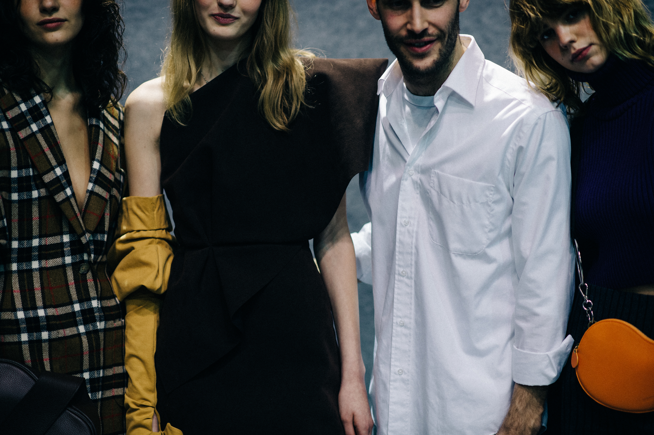 Designer with models backstage