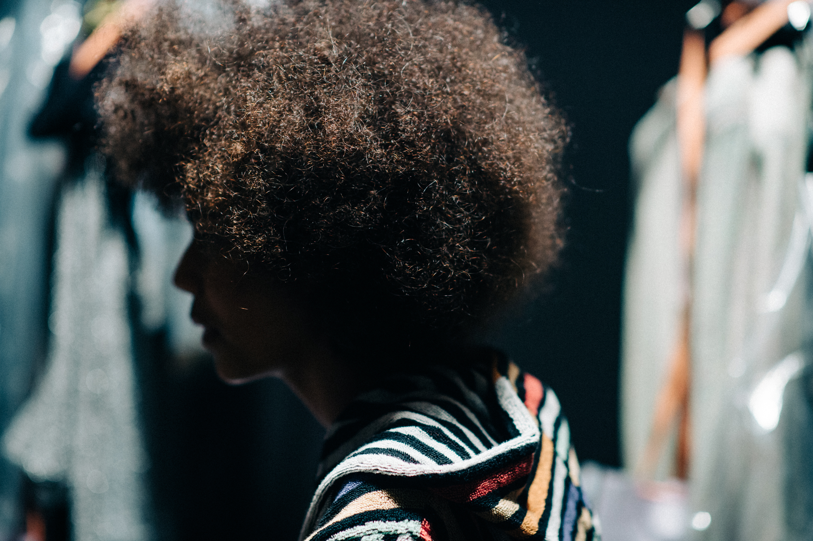 Model with curly hair before the show