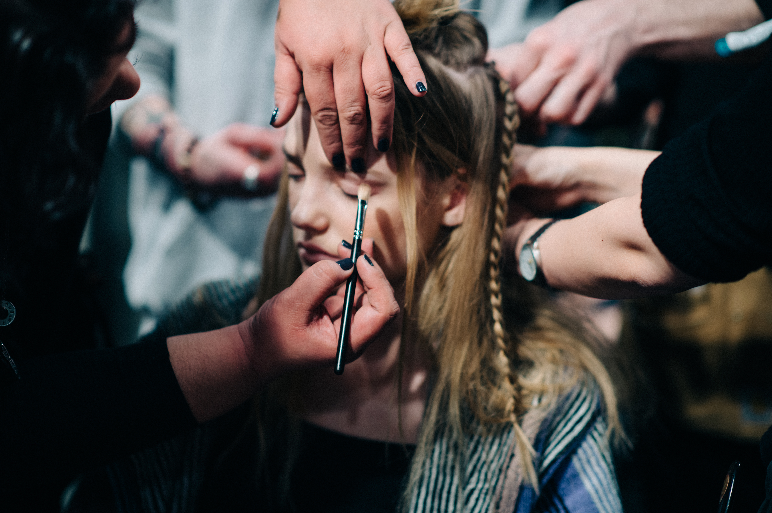 Model getting make up and hair done