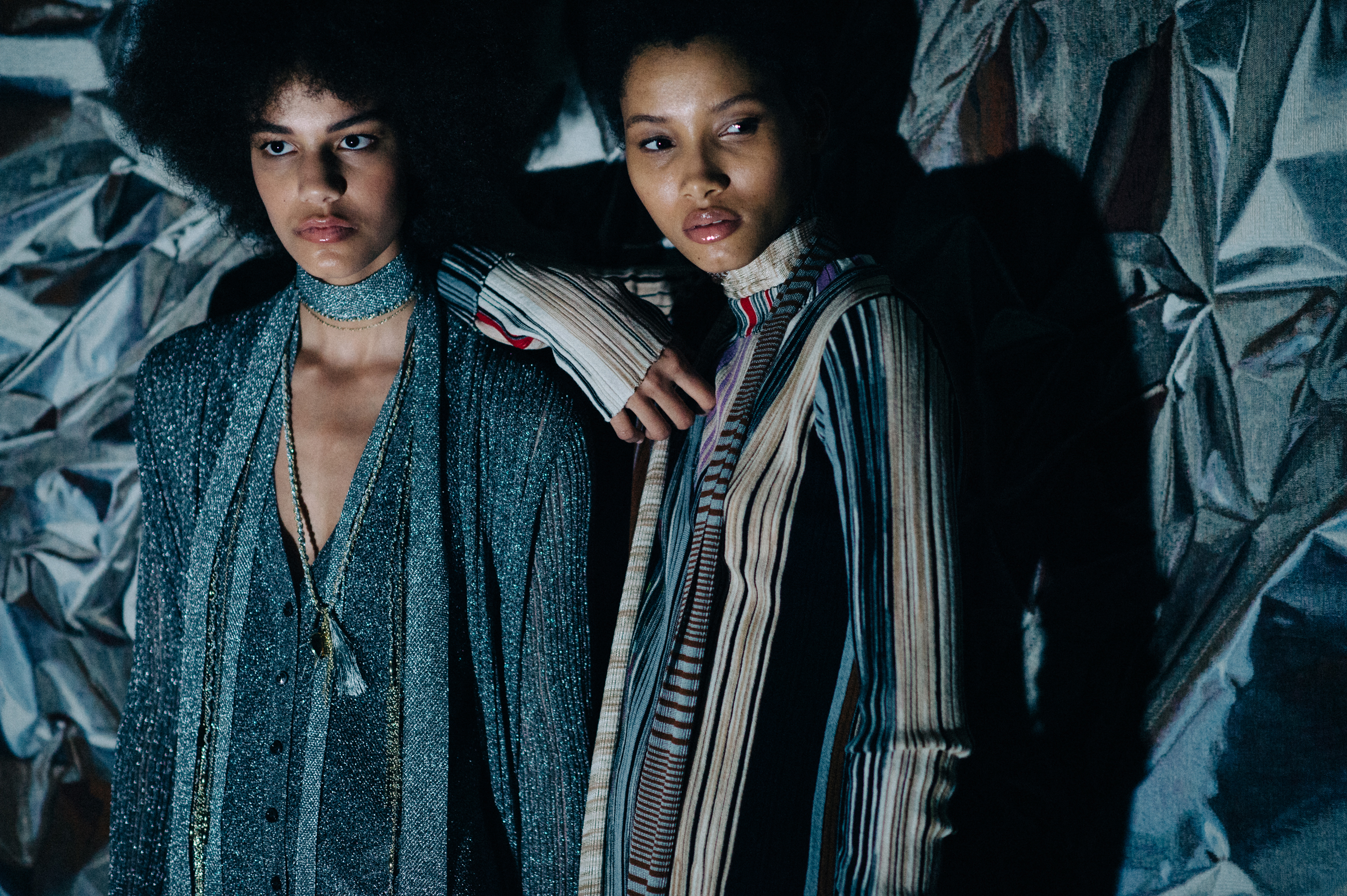 Two models wearing graphic outfits