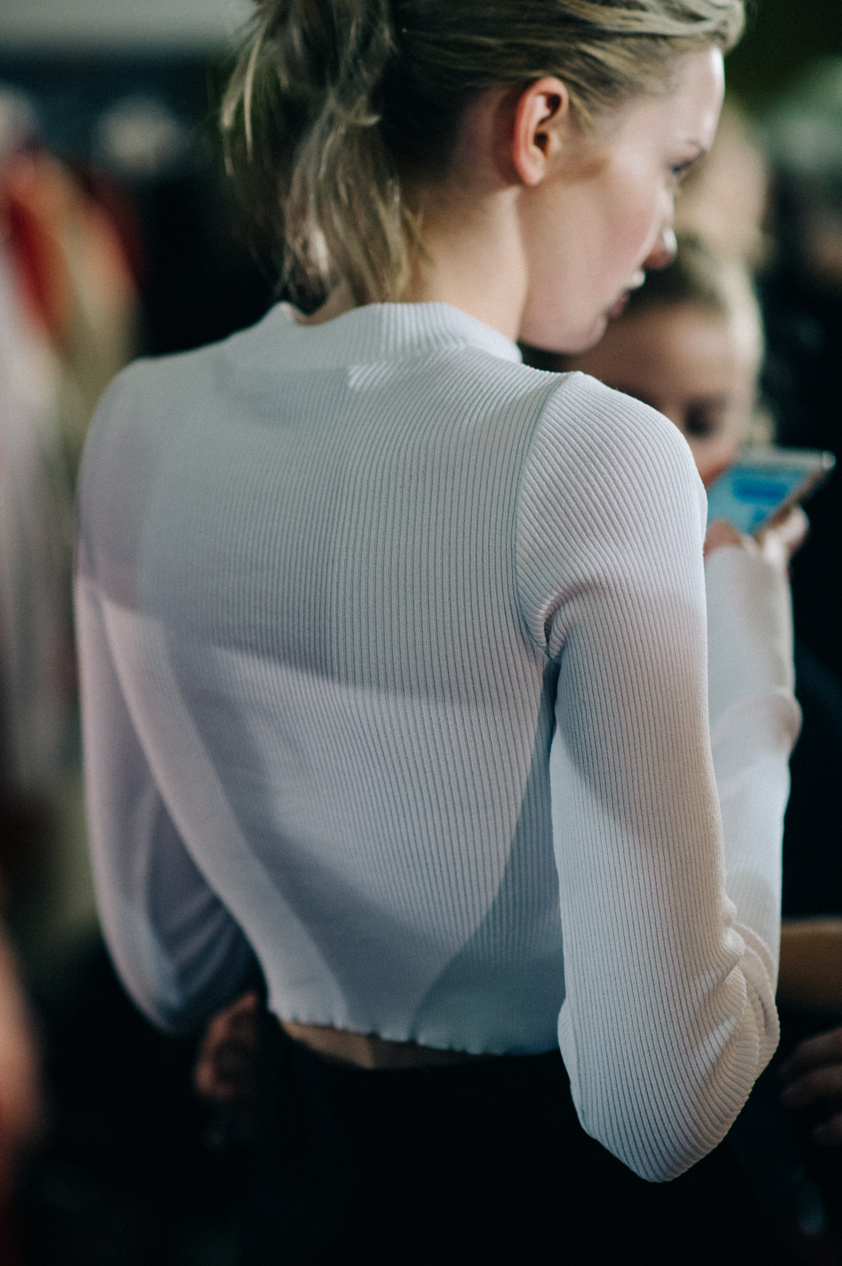 Woman wearing white sweater