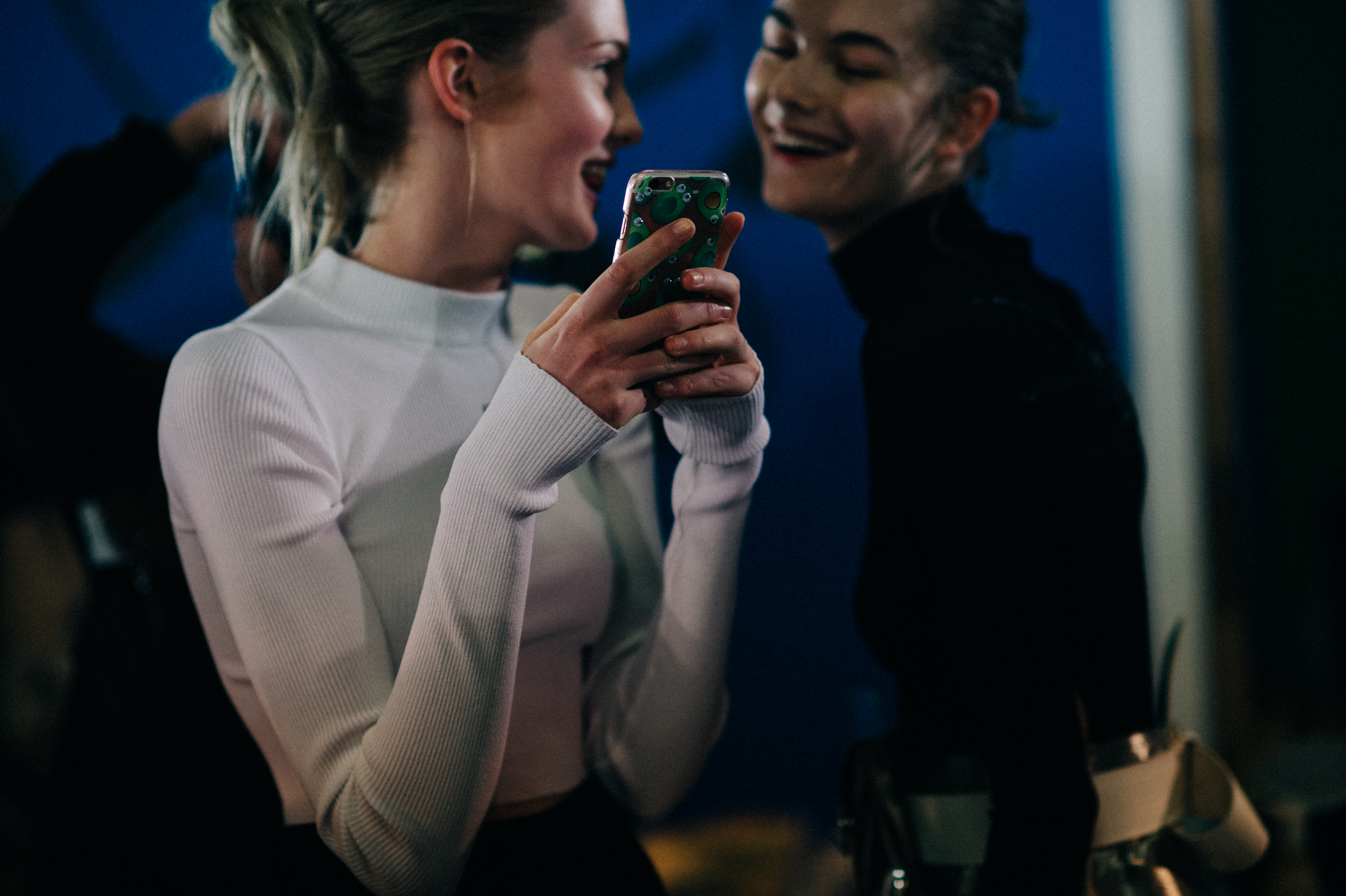 Models laughing backstage