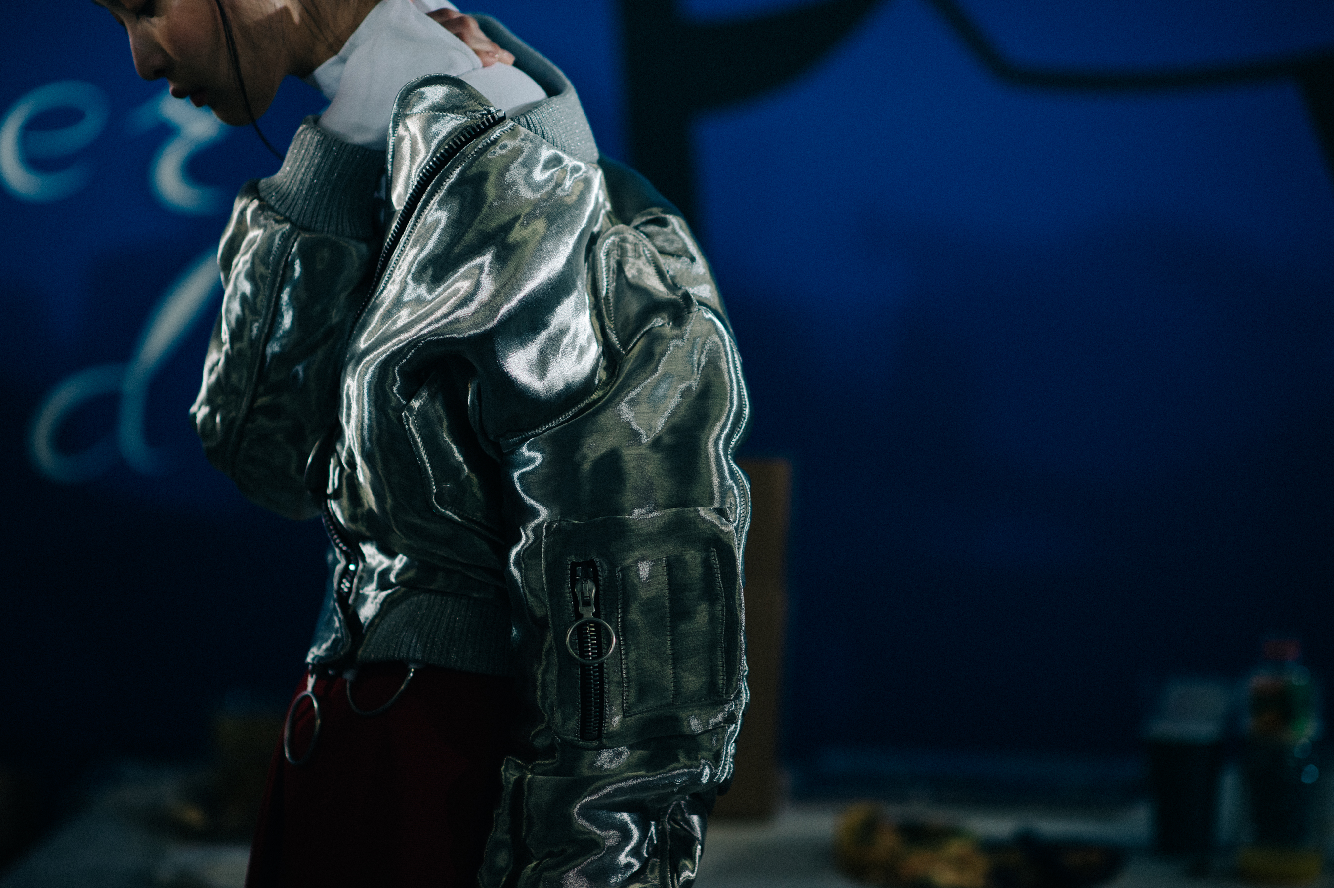 Model wearing silver jacket
