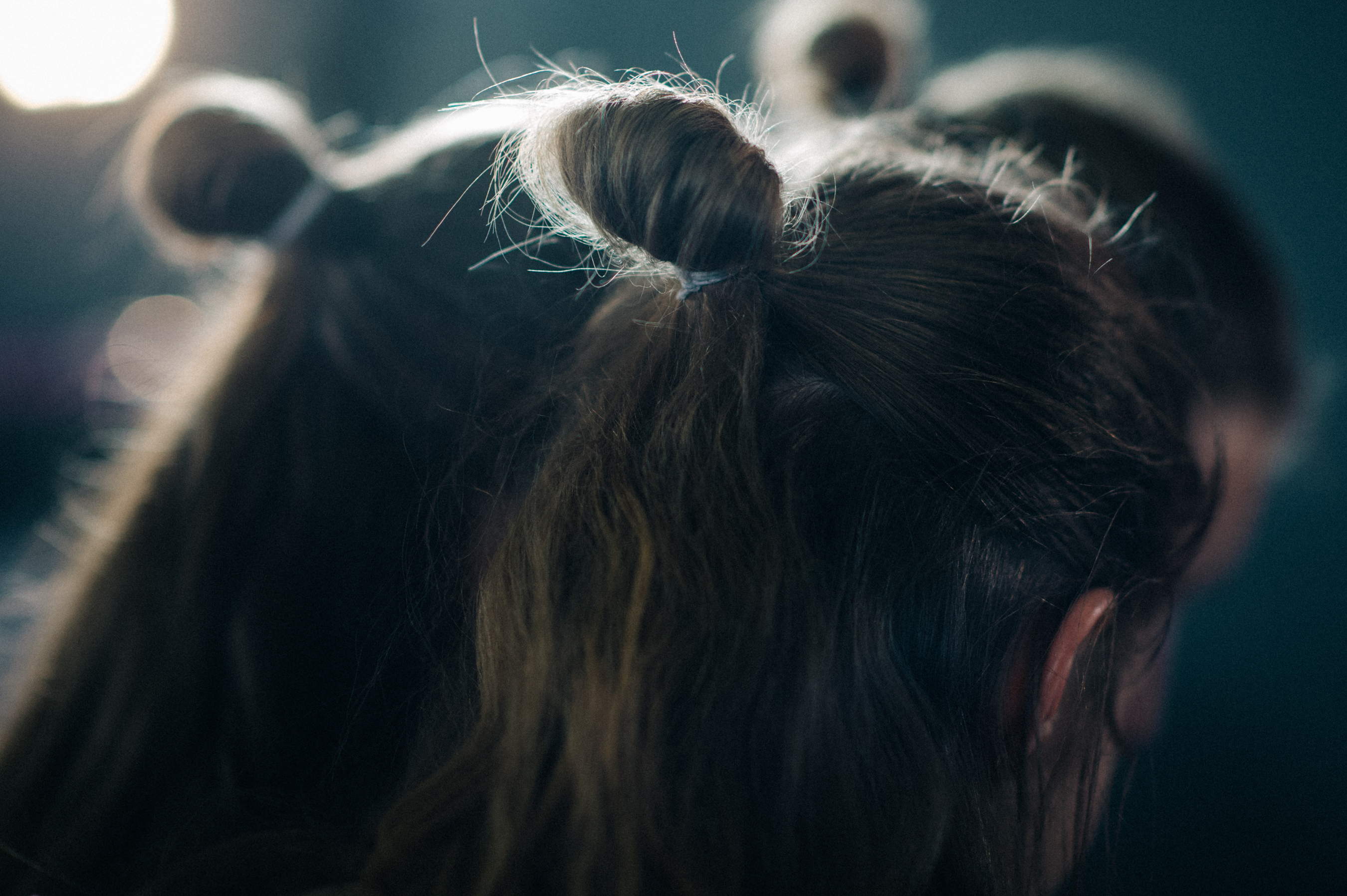 Models with tied hair before show
