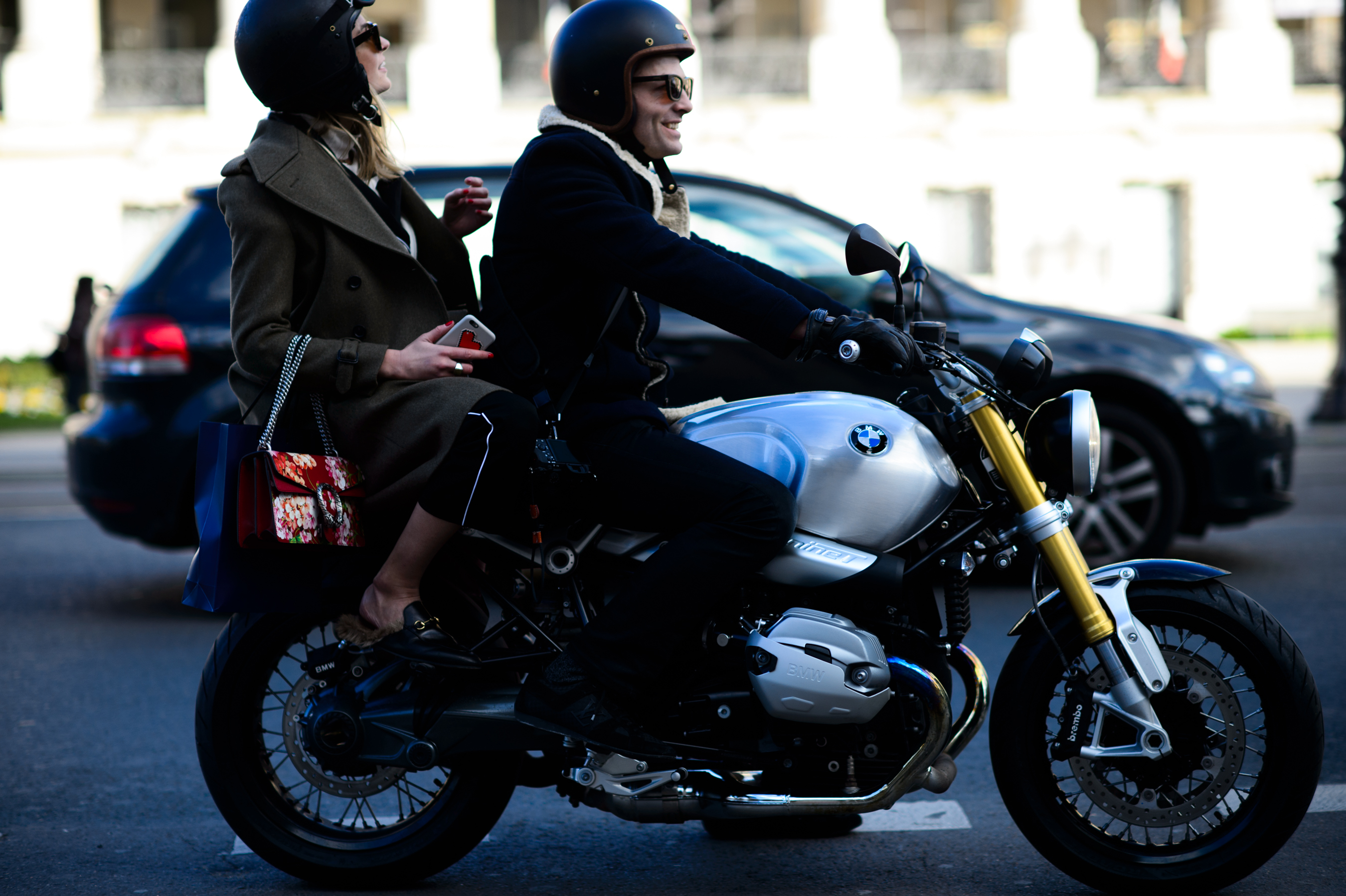 Man riding motorcycle carrying woman