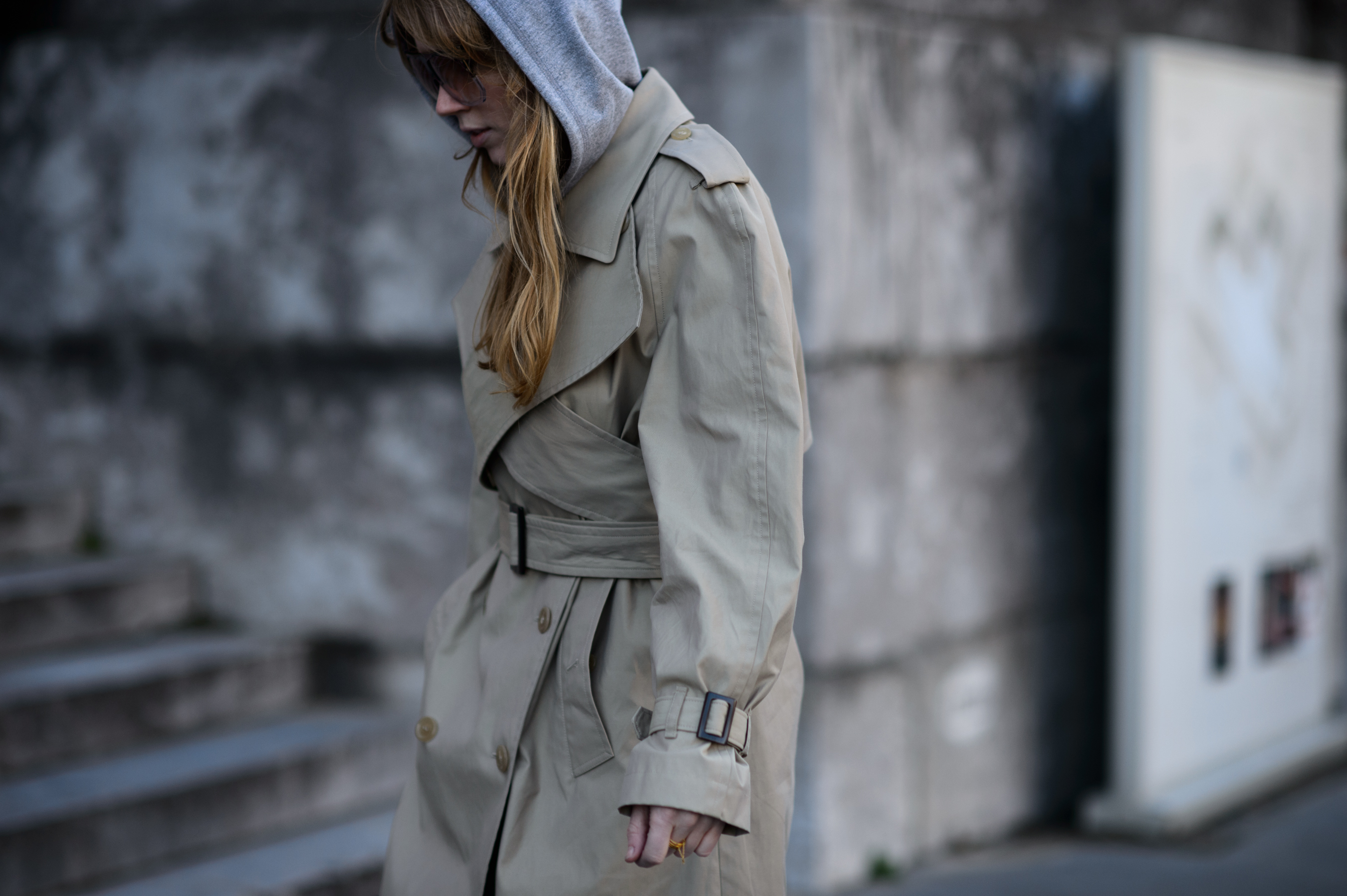 Woman wearing beige coat with grey hood