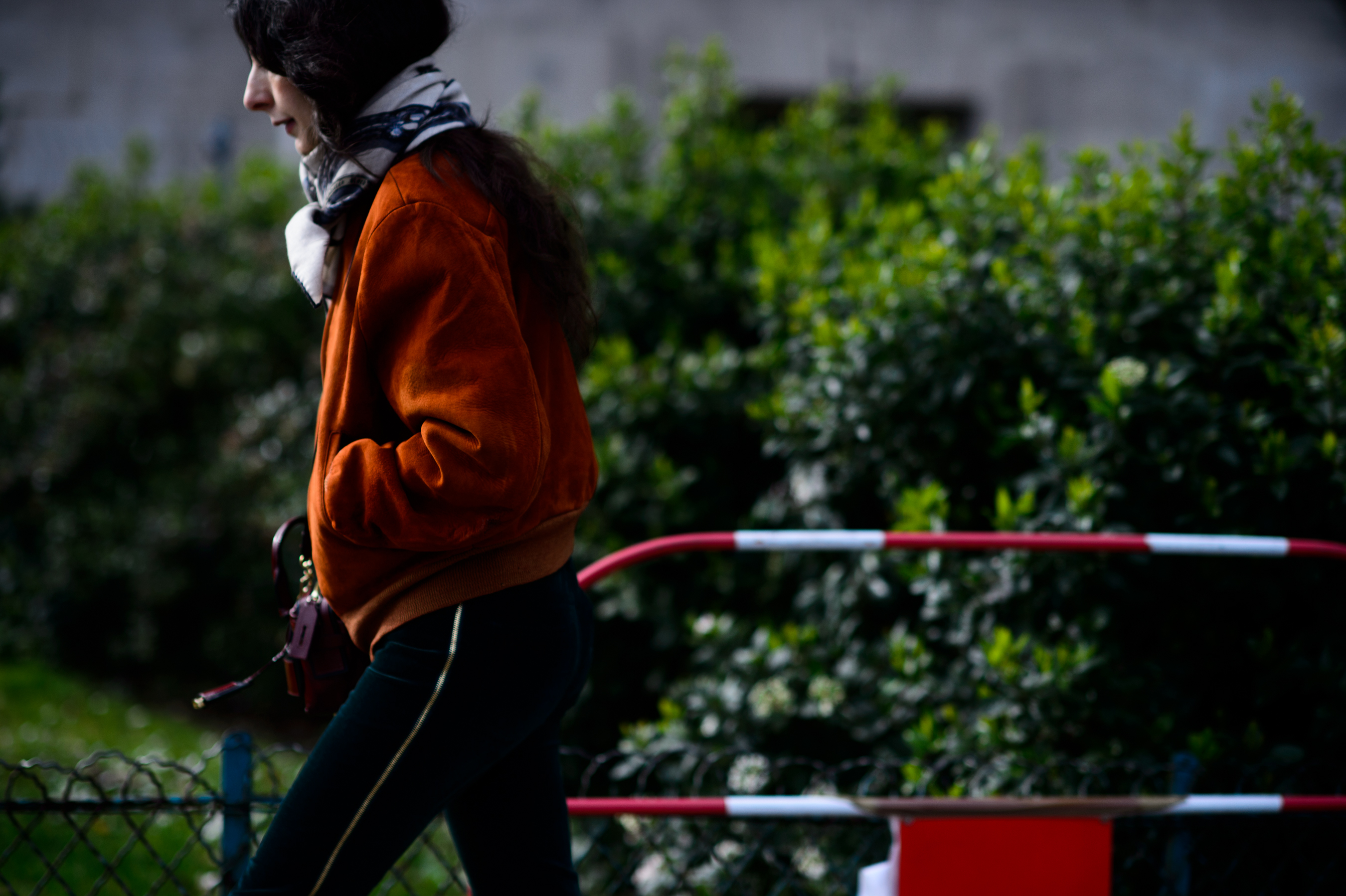Woman wearing orange bomber