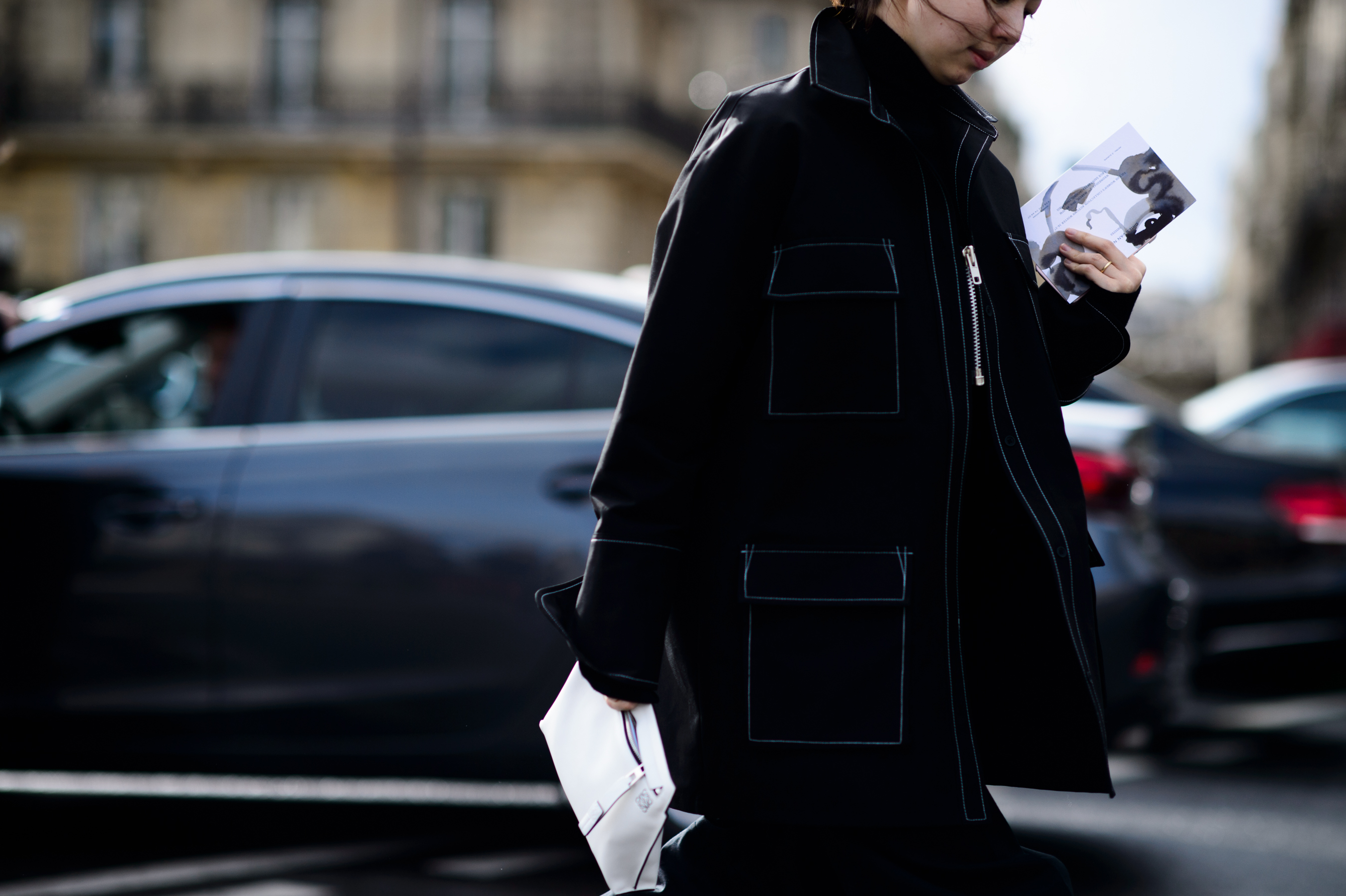 Woman wearing black coat with white details