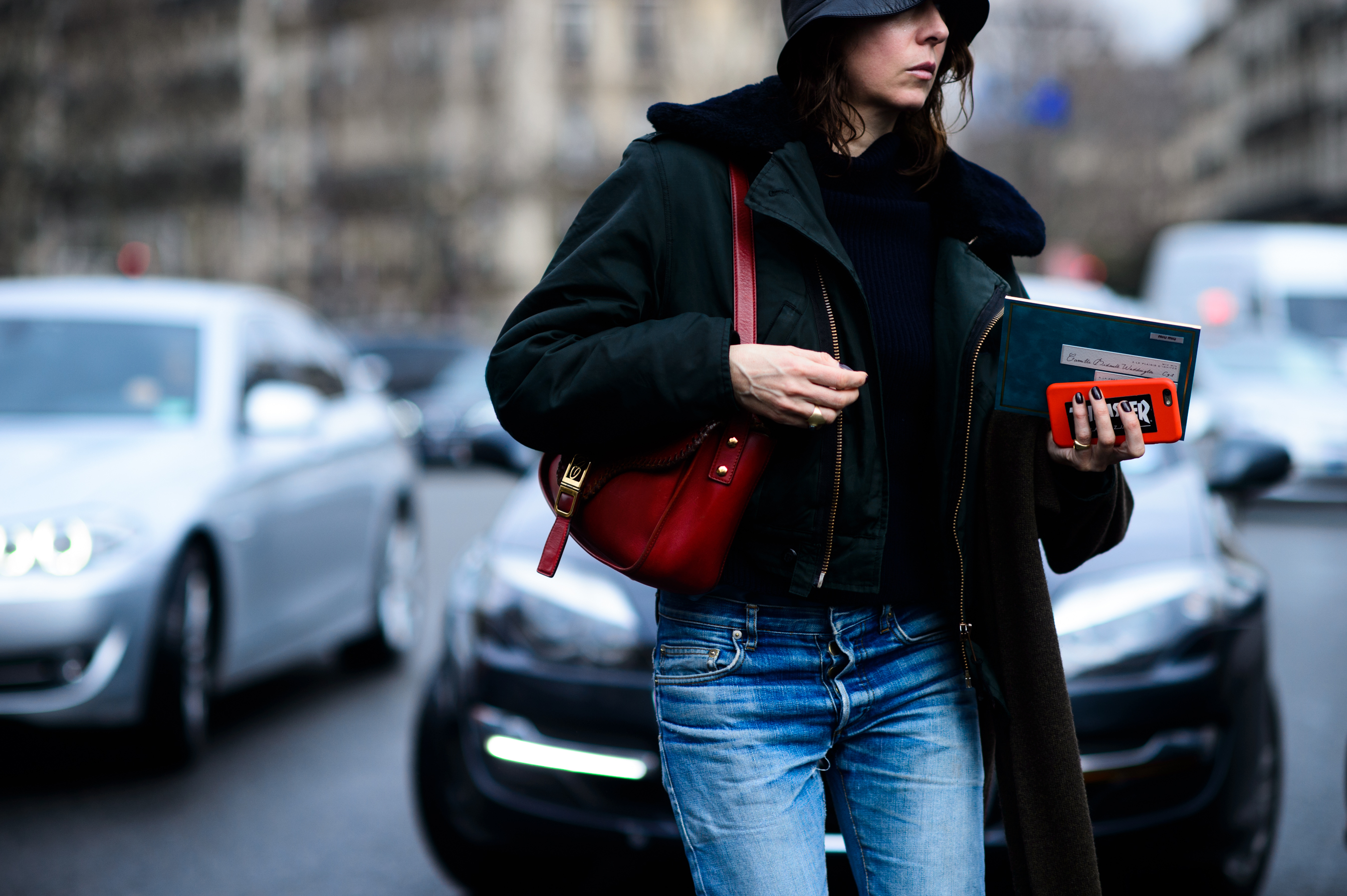 Woman in black coat and bucket hat
