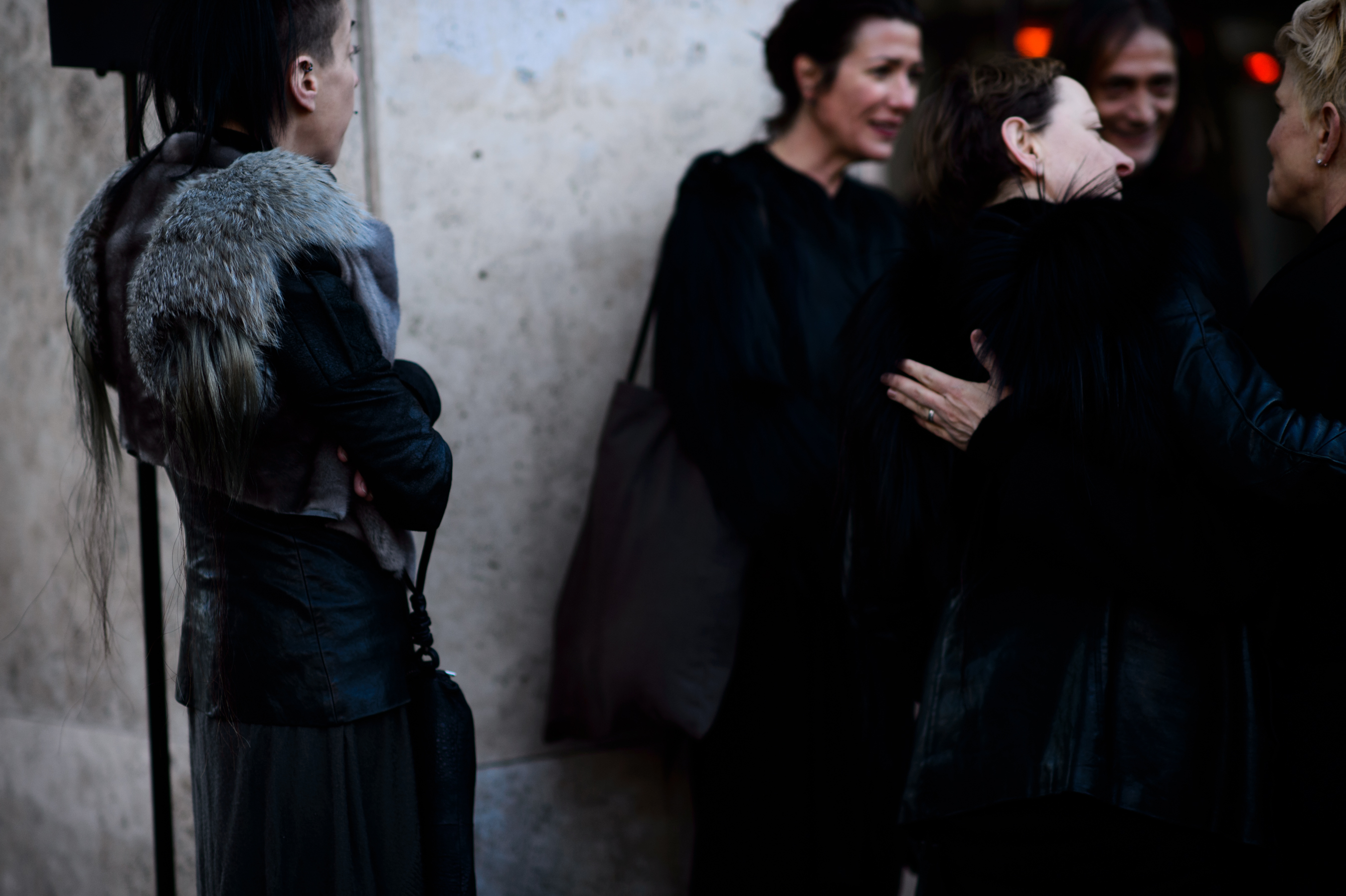 Women greet eachother before fashion show